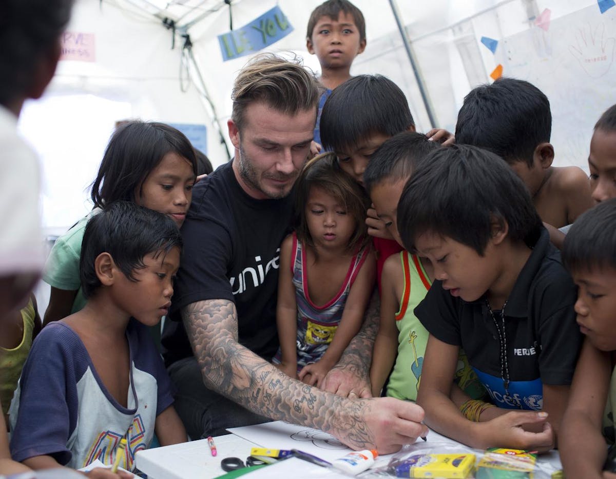 UNICEF Goodwill Ambassador David Beckham meets child survivors of Typhoon Haiyan at a UNICEF-supported child friendly space at one of Taclobanâ