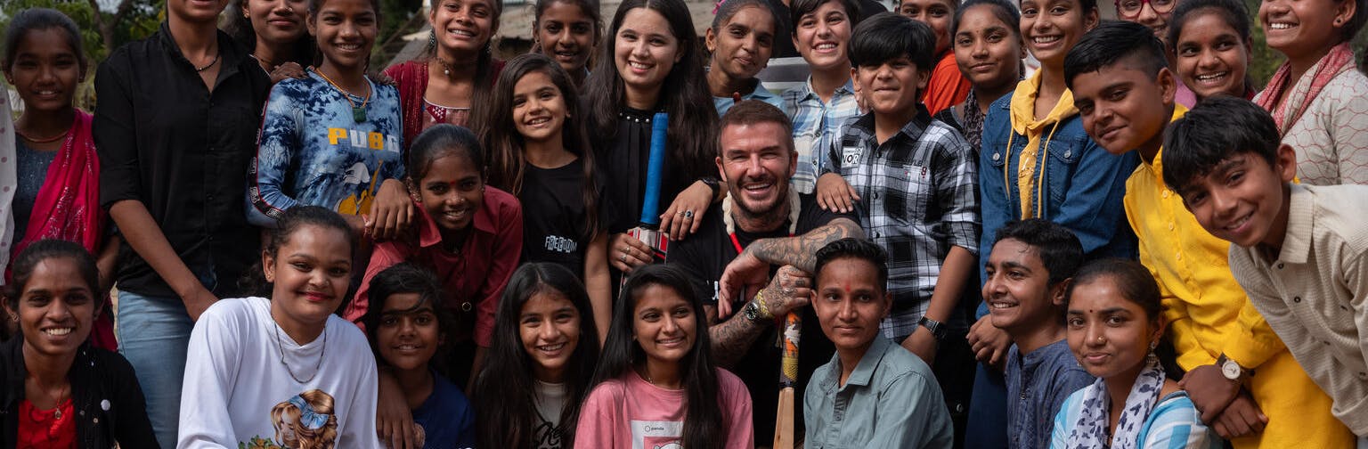 UNICEF Goodwill Ambassador David Beckham (centre) poses for a group photo with adolescents at the community centre in the Banaskantha district of Gujarat state.