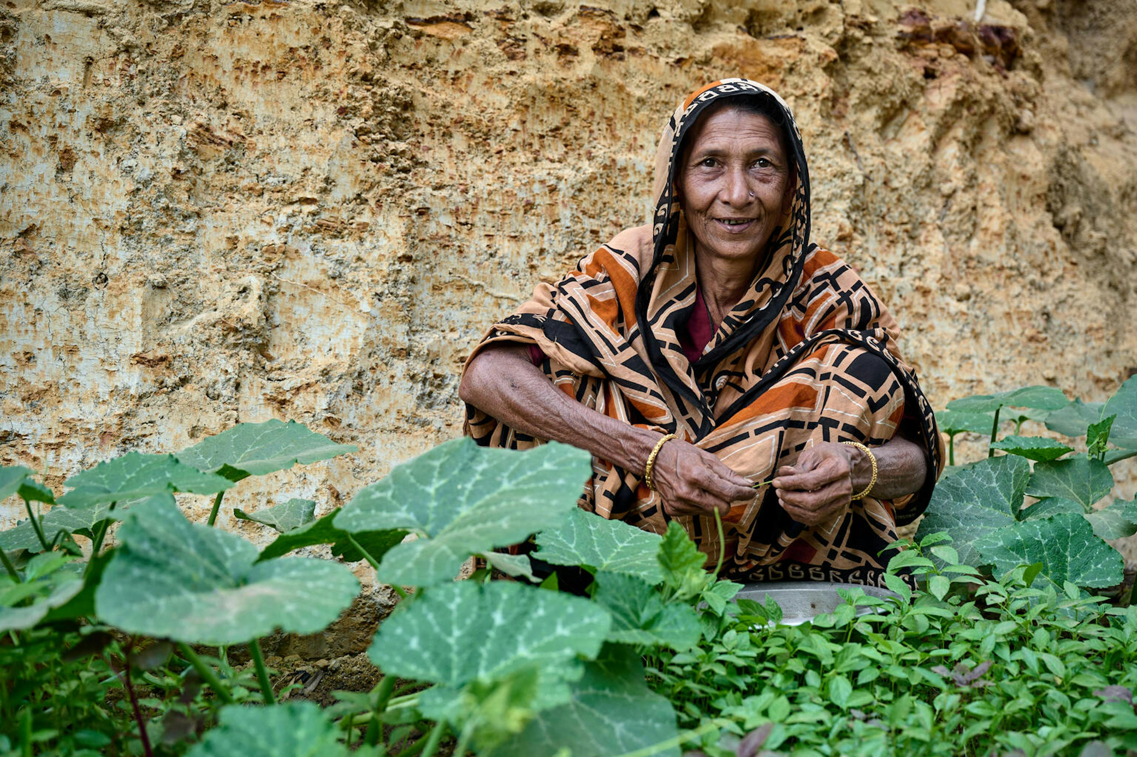 Altaj Begum (50) showing off the produce grown from her homestead garden in Cox's Bazaar, Bangladesh.