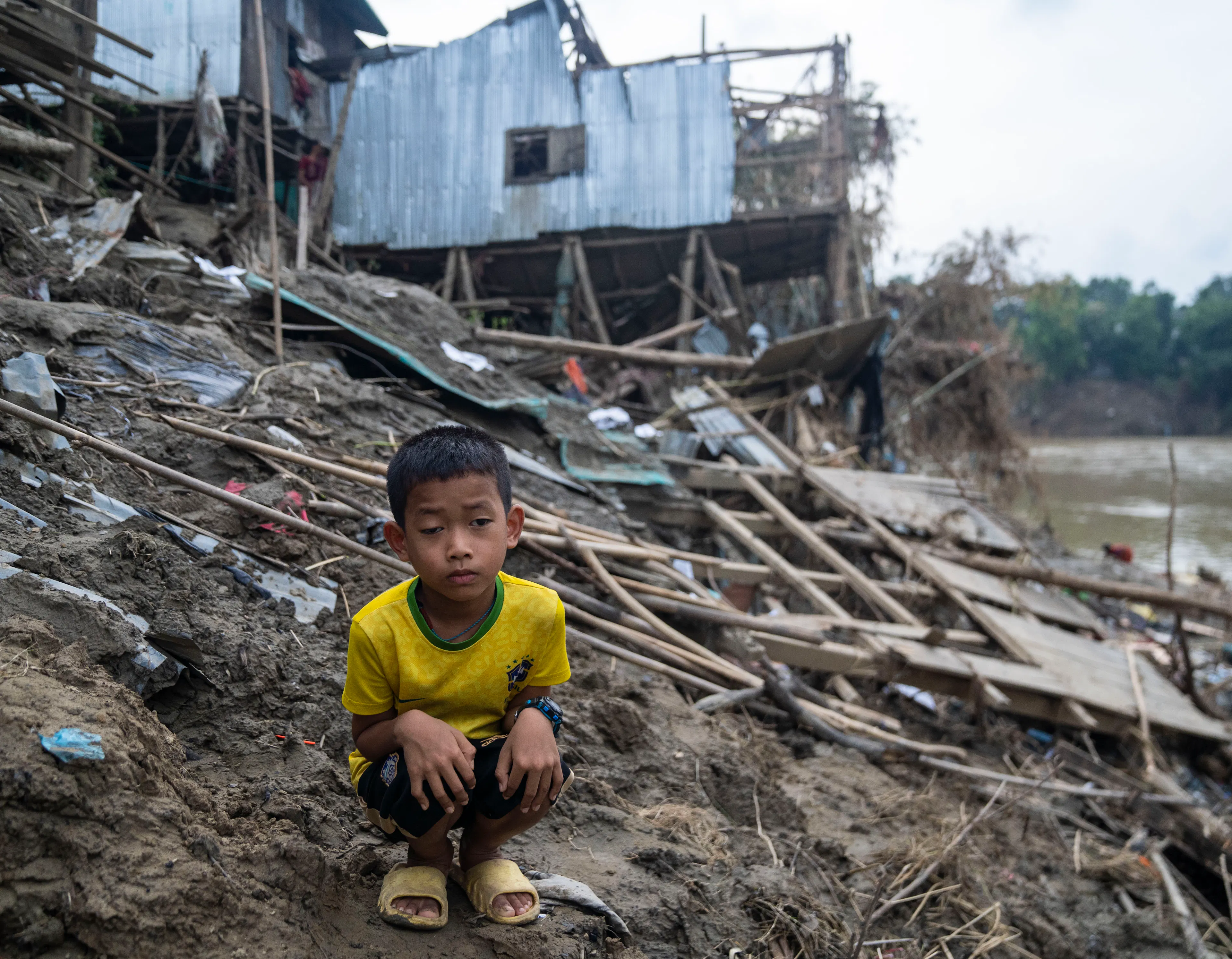 Phue Chai, 7, found refuge in a school during the flood. Now, as the school prepares to reopen, he's homeless once again.