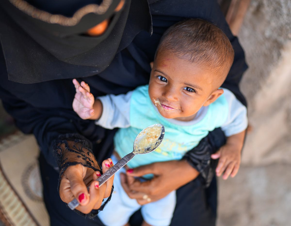 7-month-old baby boy Sanad is fed by his mother, Raneem Hani Ahmed Hasan.