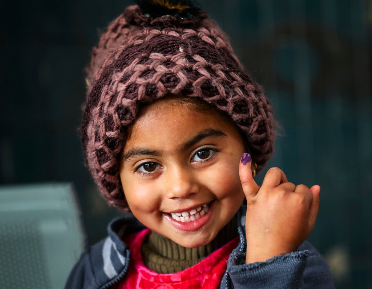Ajwa, 4, shows off the ink mark on her little finger, which confirms that she has received polio vaccine.