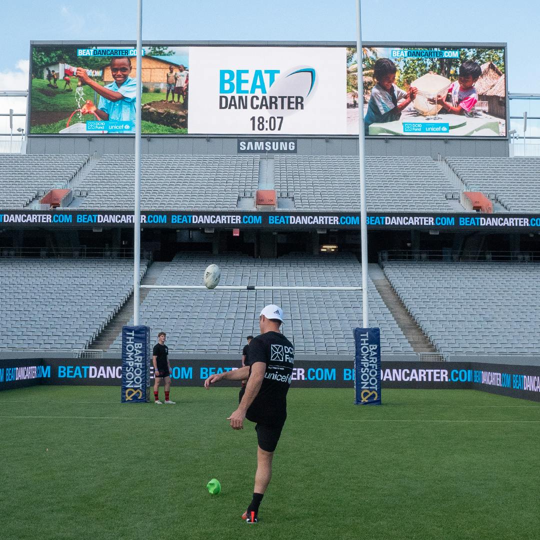 A girl throwing the ball at Eden Park for the Beat Dan Carter challenge