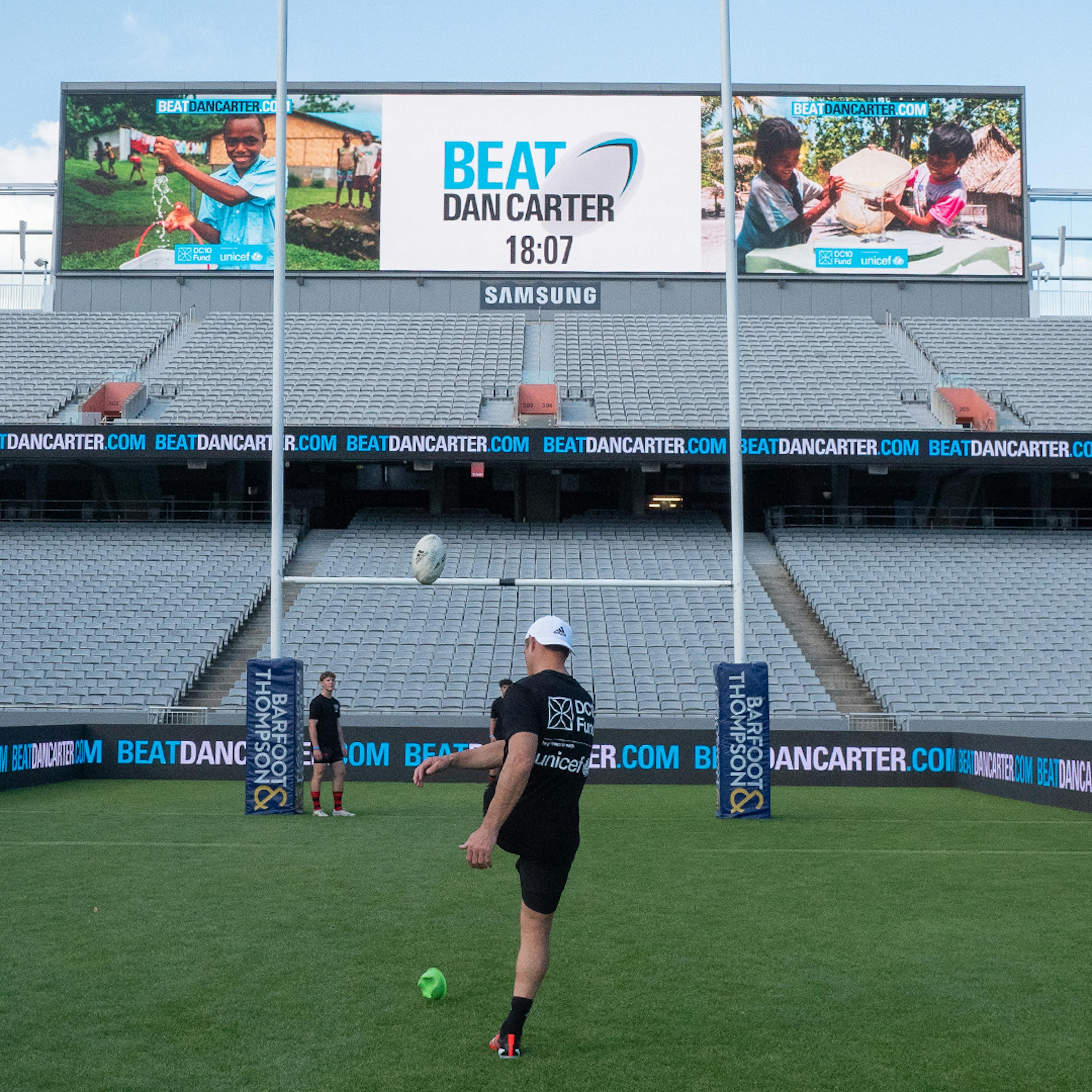 A girl throwing the ball at Eden Park for the Beat Dan Carter challenge