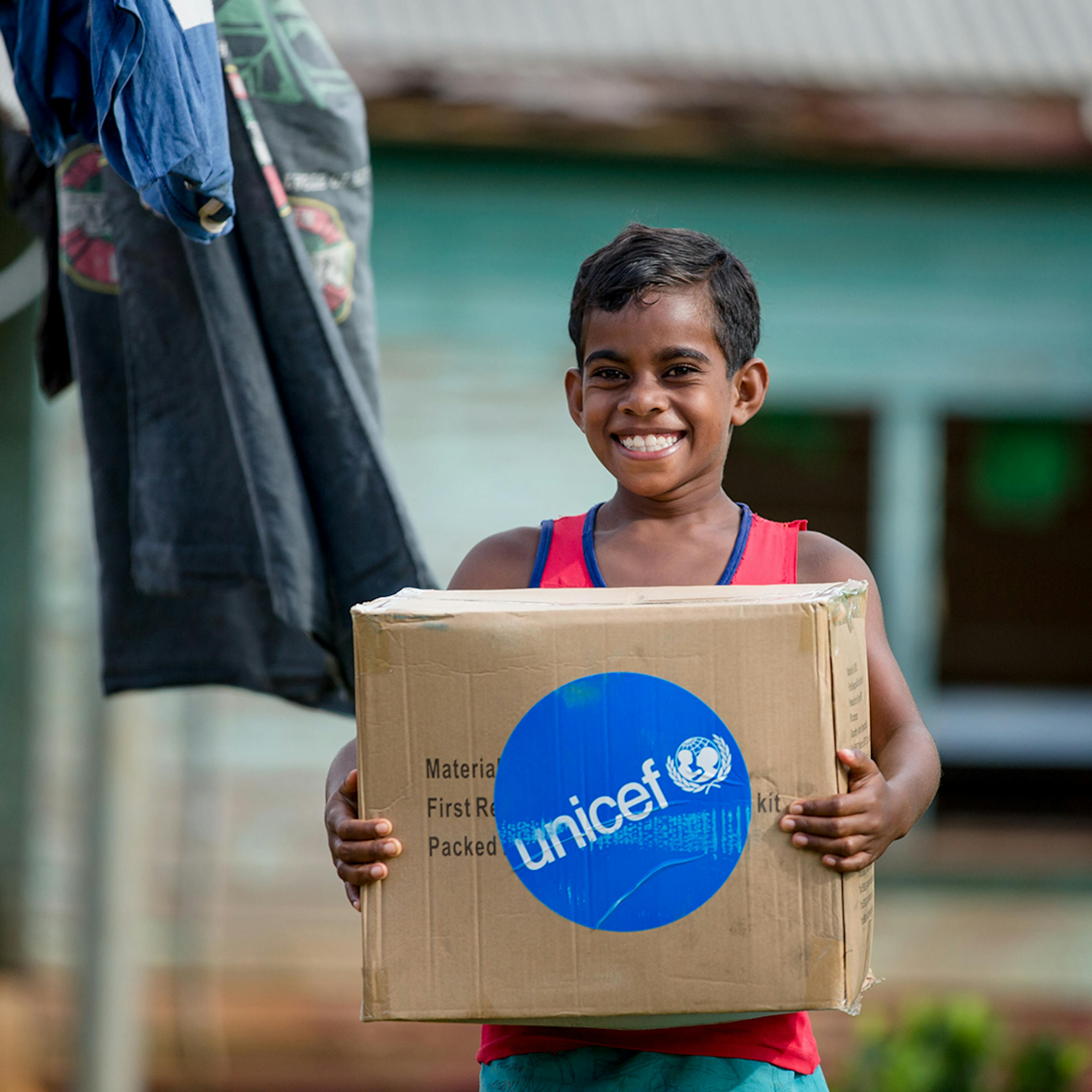 On 23 December 2020, 8-year-old Asinate Catanavula receives a Water & hygiene kit at Tavea Village,Bua - Fiji.