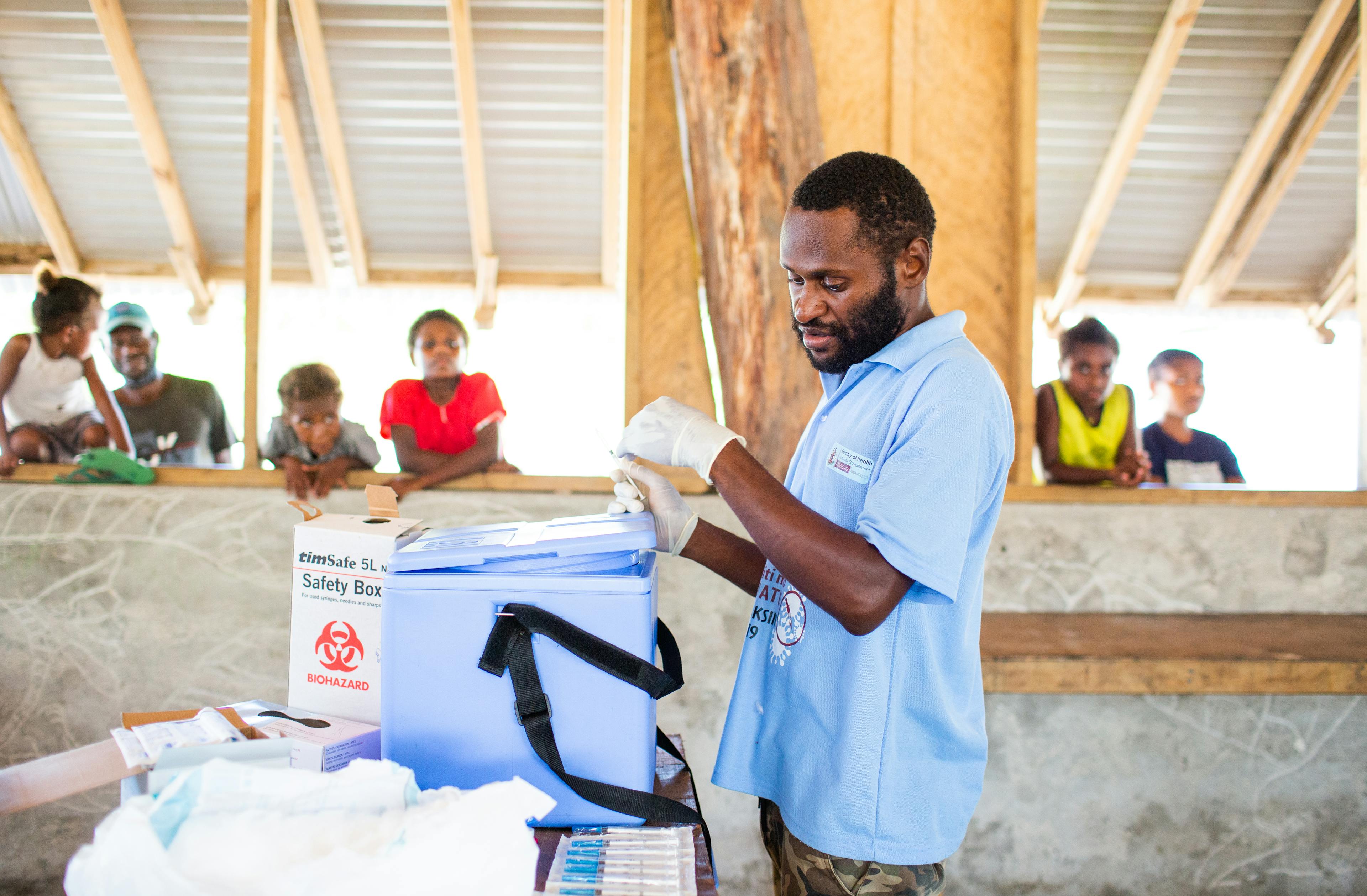 Registered Nurse Enok Tarip Vaccinates Albert Tamata (73). "When I heard talks that you were coming today I was glad," says Albert, " God is helping us by sending this team to our village."Journey of a health worker. Covax Covid-19 Vaccination roll out in Laonamoa Village, Pele Island, North Efate, Vanuatu.