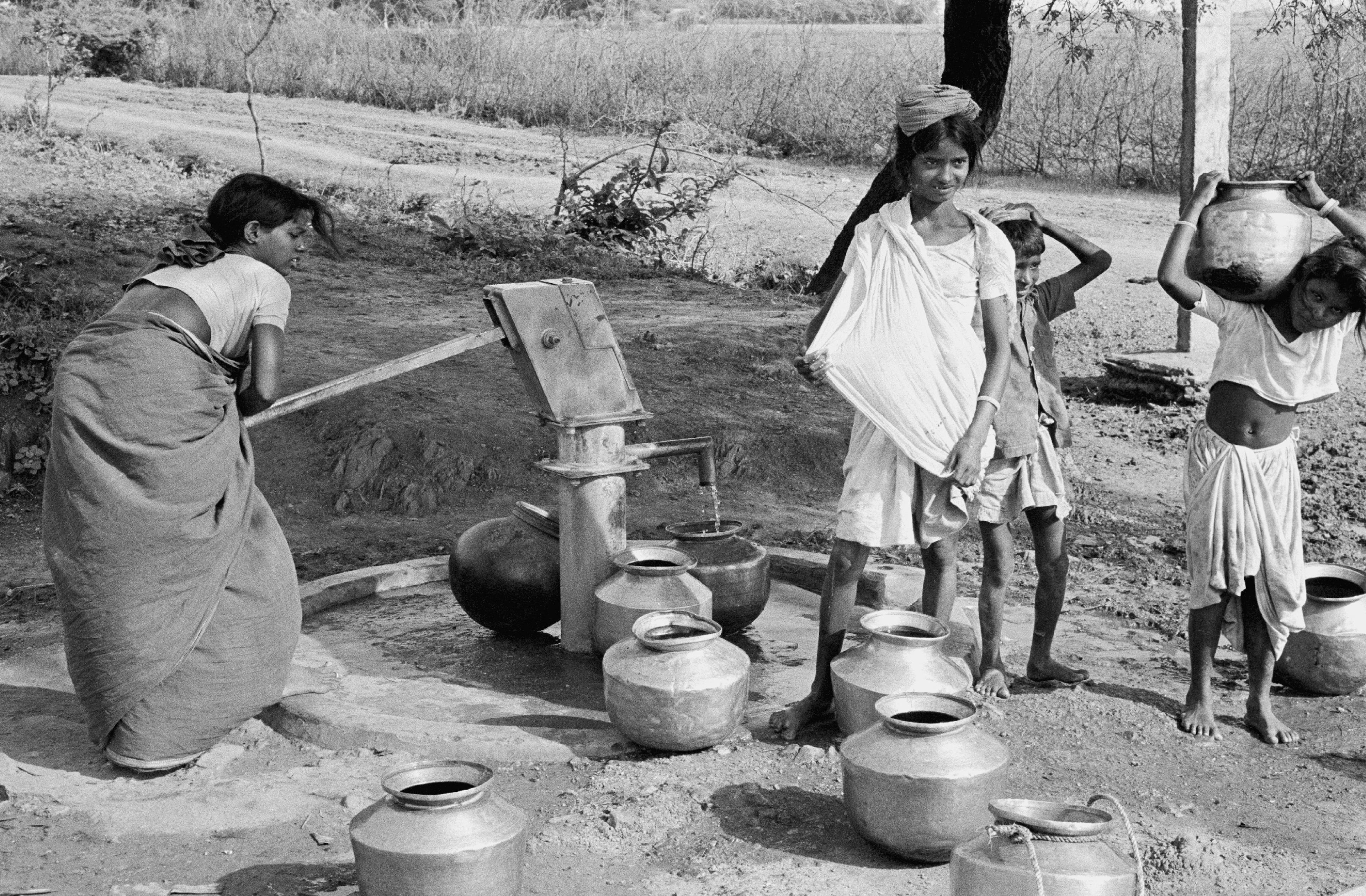 Children collect water at a handpump in a village in the southern state of Andhra Pradesh, India.