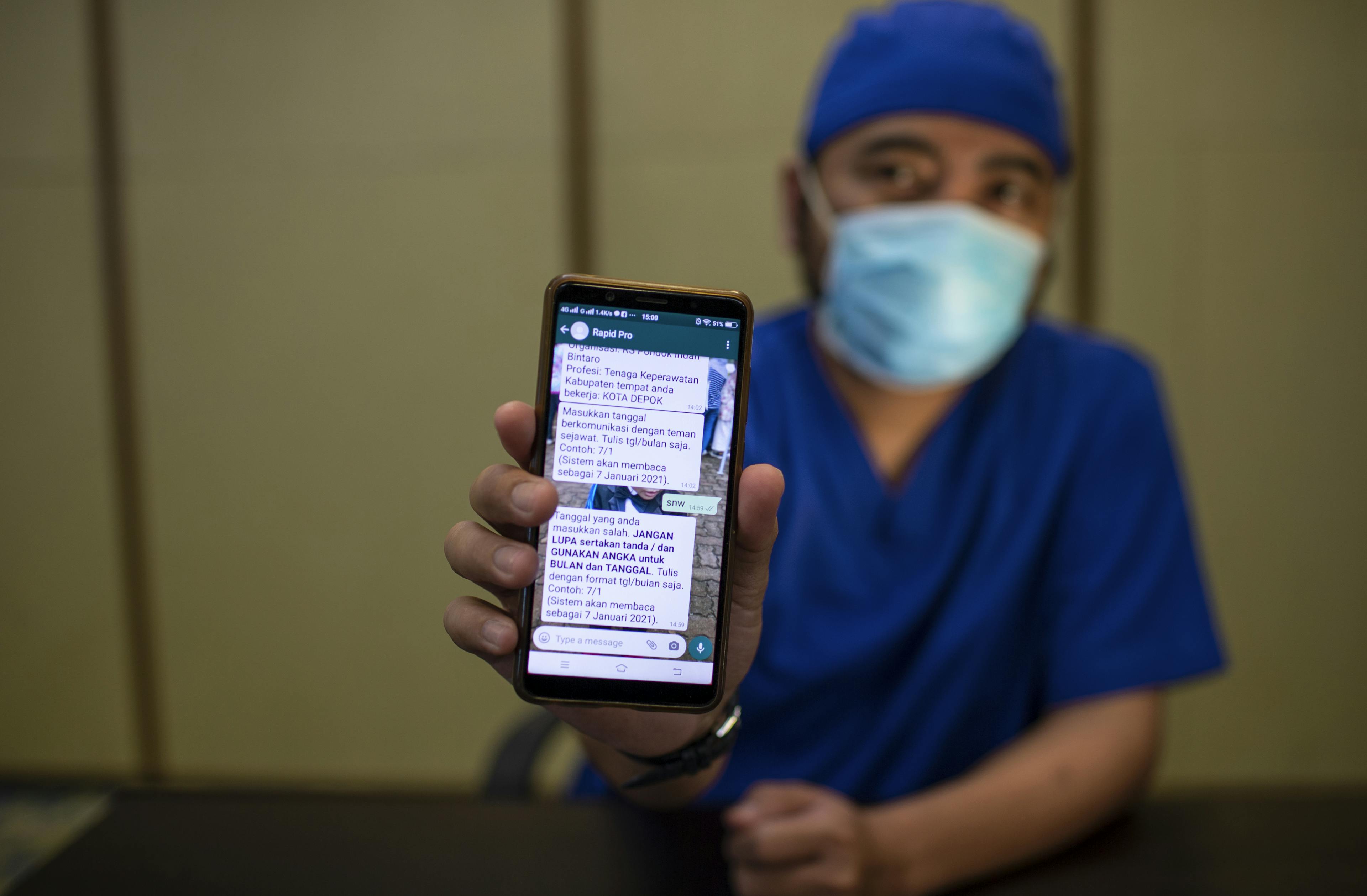 Stevanus Agus Rahardjo, an emergency room nurse, shows the RapidPro application on his smartphone while attending an online training at Pondok Indah Bintaro Hospital in South Tangerang, Indonesia, on 18 February 2021.