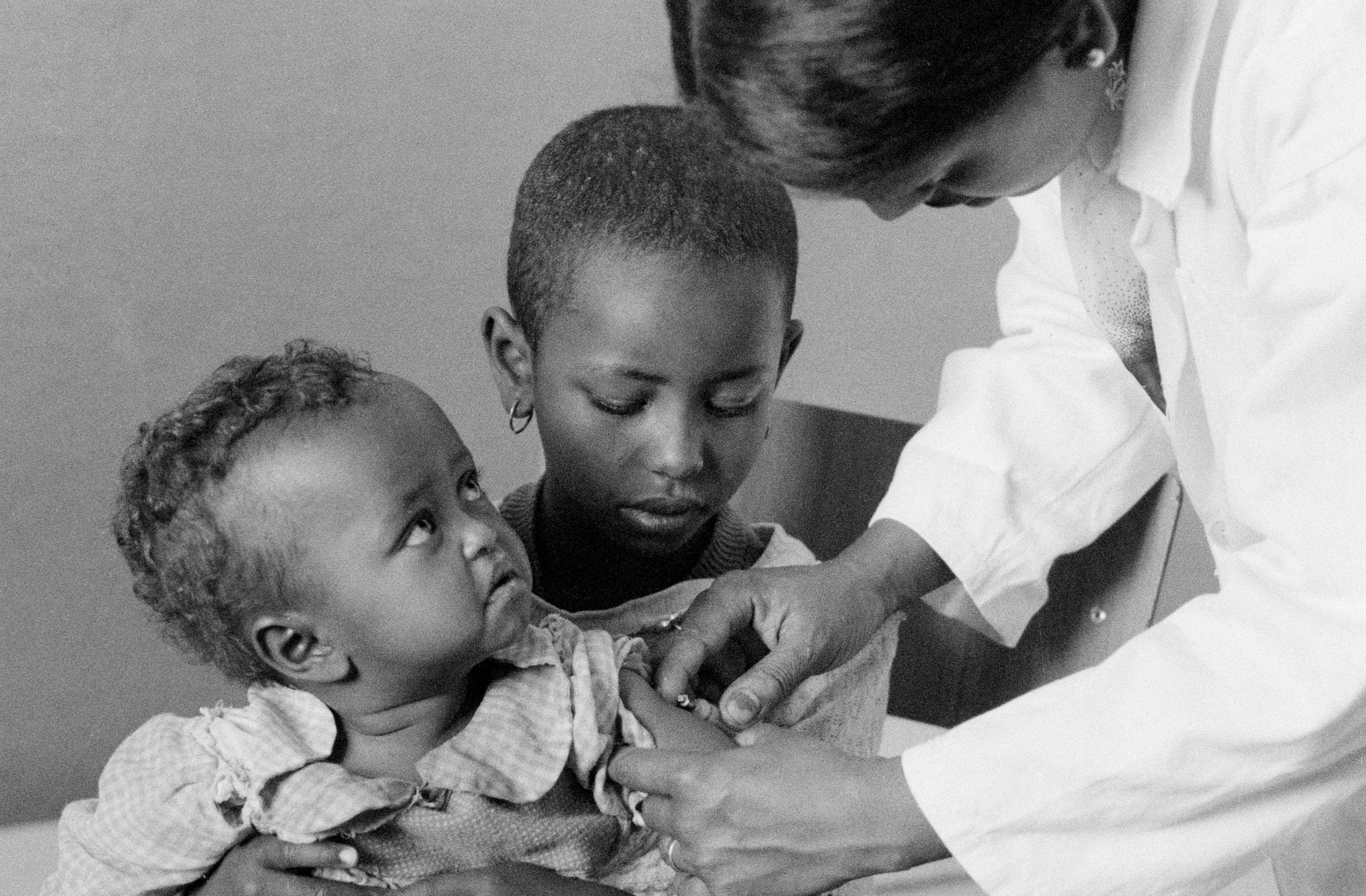 A little girl looks up at the nurse who is vaccinating her, at a health centre in the city of Asmara in the northern Eritrea Province, Ethiopia.