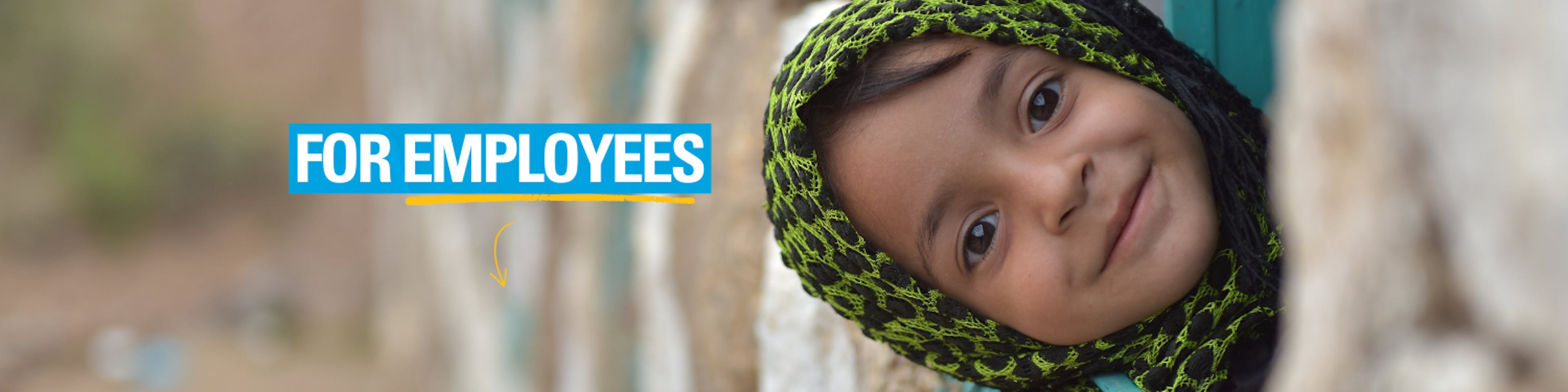 Monira who has recovered from malnutrition is sitting on the window of her house.