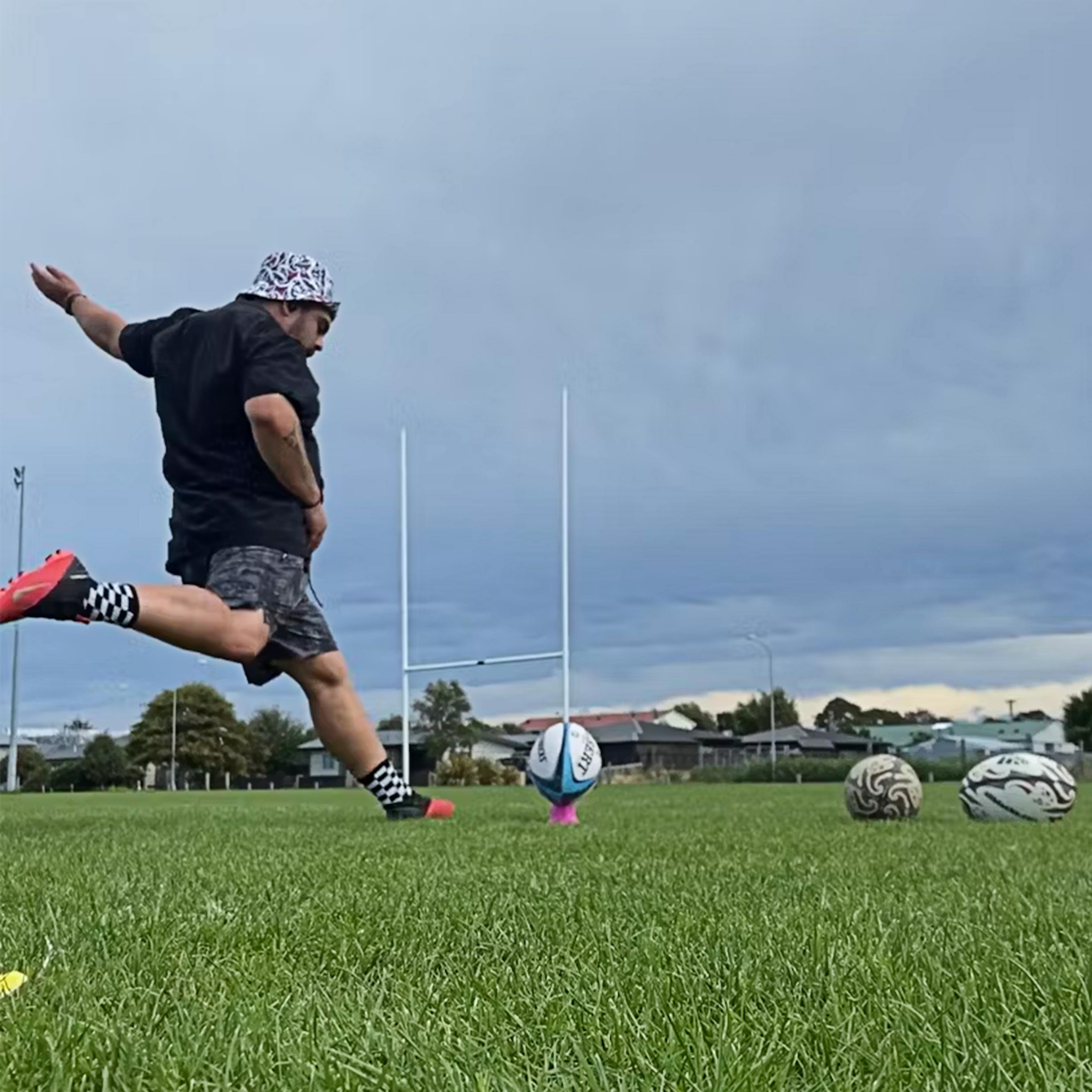 Josiah, a BDC participant, kicking a rugby ball