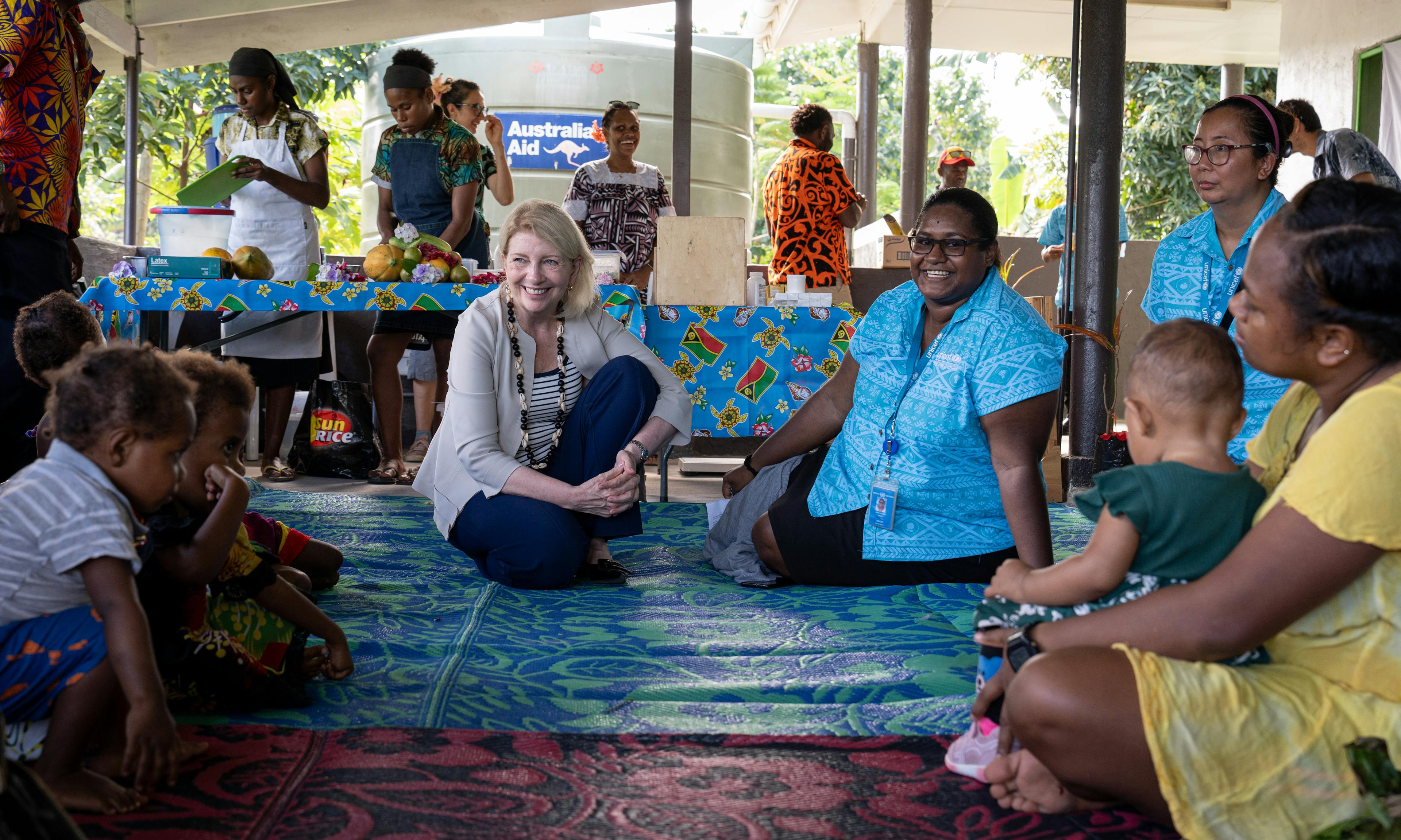UNICEF Executive Director Catherine Russell and UNICEF Health and Nutrition Officer Leah Louisa Tokon speak to mothers and children at Mele Health Centre on Efate Island in Vanuatu.