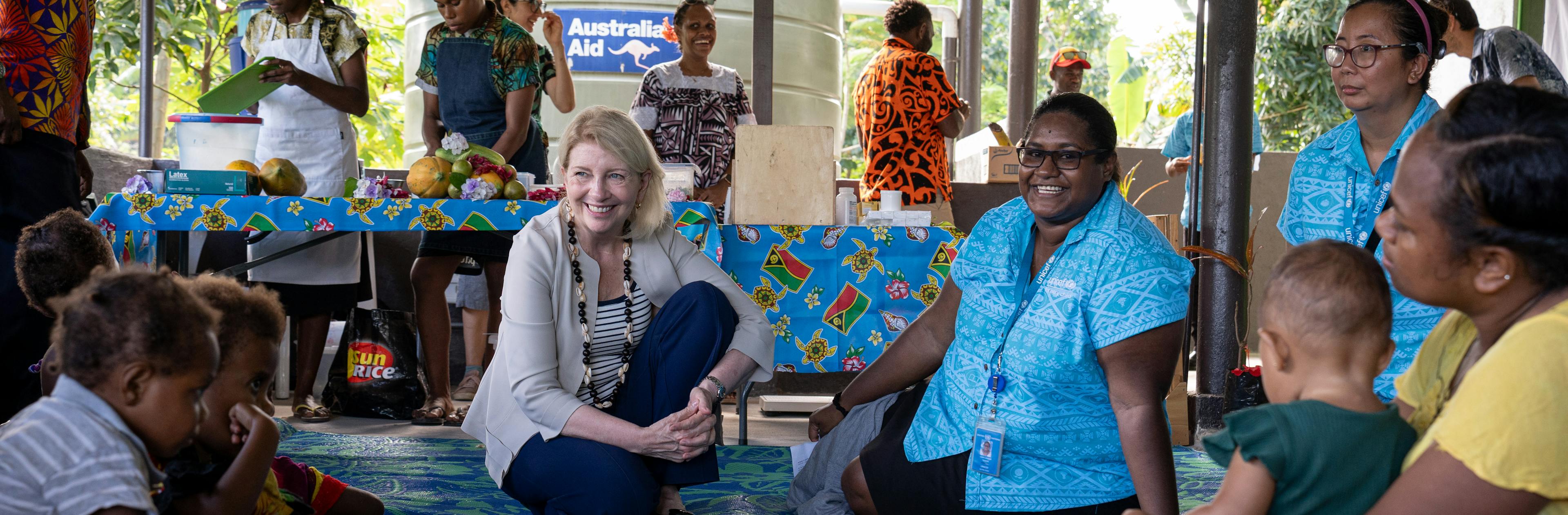 UNICEF Executive Director Catherine Russell and UNICEF Health and Nutrition Officer Leah Louisa Tokon speak to mothers and children at Mele Health Centre on Efate Island in Vanuatu.