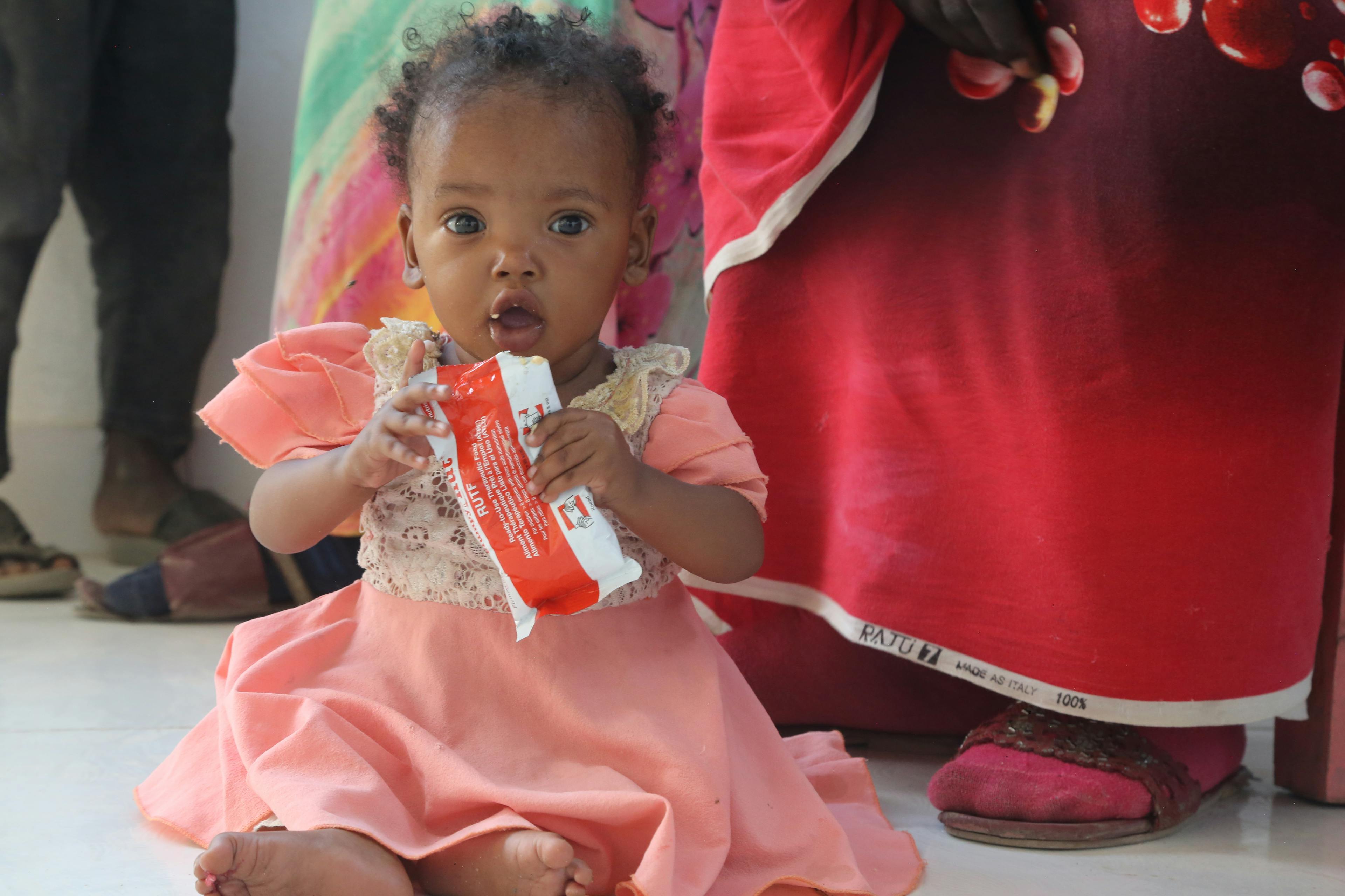7-months-old Genan eats read-to-use-therapeutic food, during a visit to Damazine Children's hospital in Damazine, Blue Nile state, Sudan, where she is admitted on a nutrition programme for treatment of malnutrition.