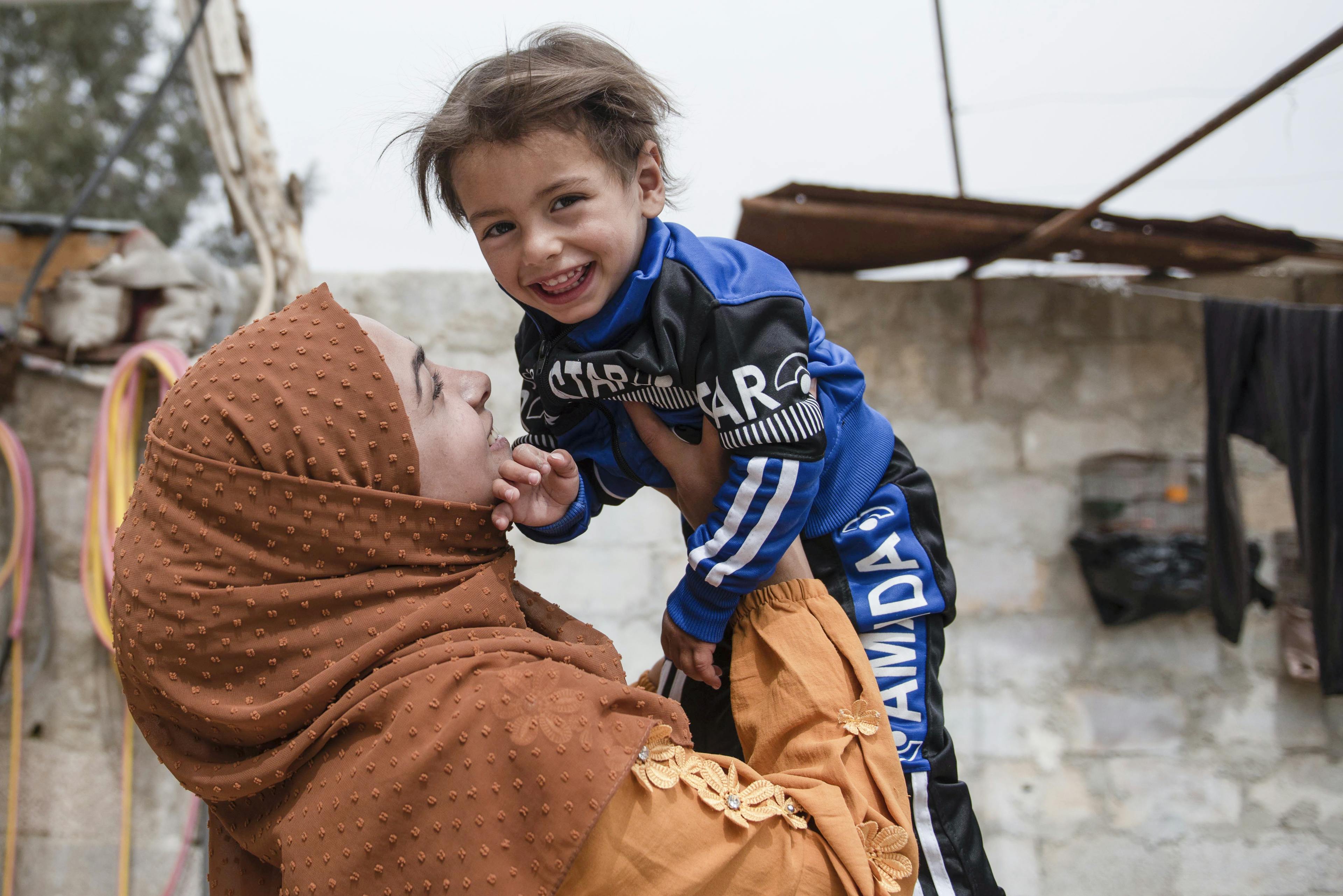 22-year-old Abir, holds her son Ishak, in their house in rural Damascus, Syria, after his recovery from malnutrition.