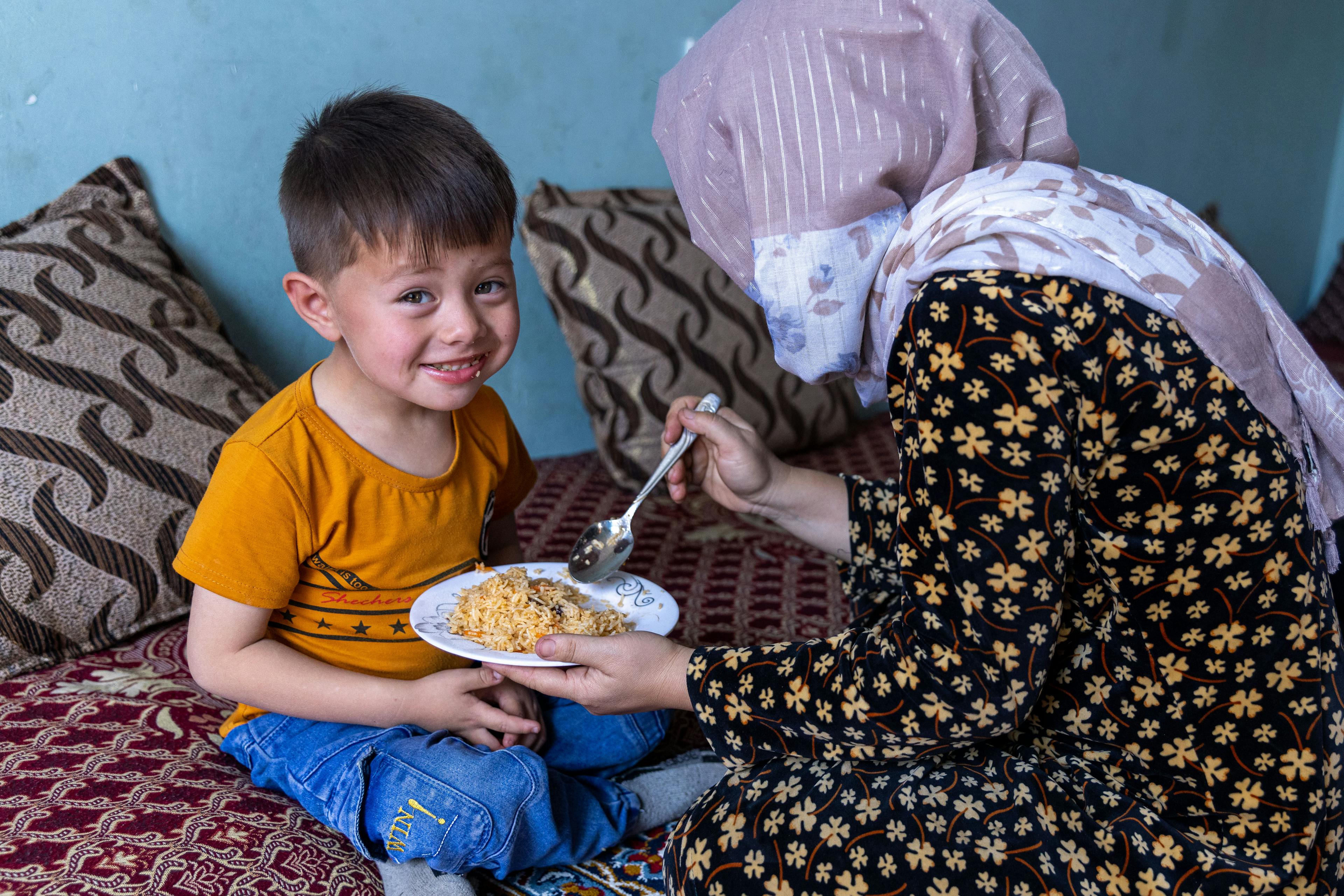 4-year-old Mokhtar eating a meal with added micronutrient supplements at home in Mazar, Afghanistan.