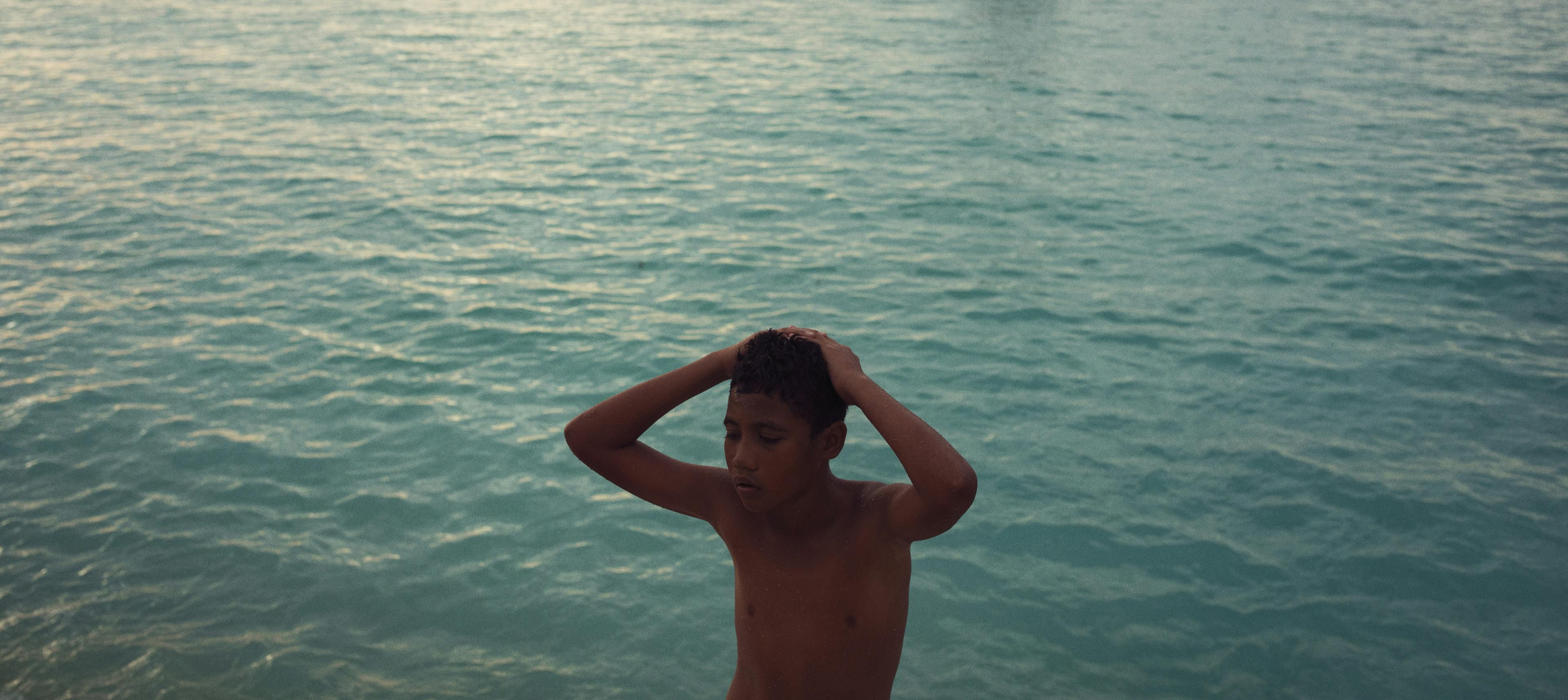 12-year-old after jumping into the sea from the sandbag staircase at ‘The Reclaimed Land’ in Tuvalu.