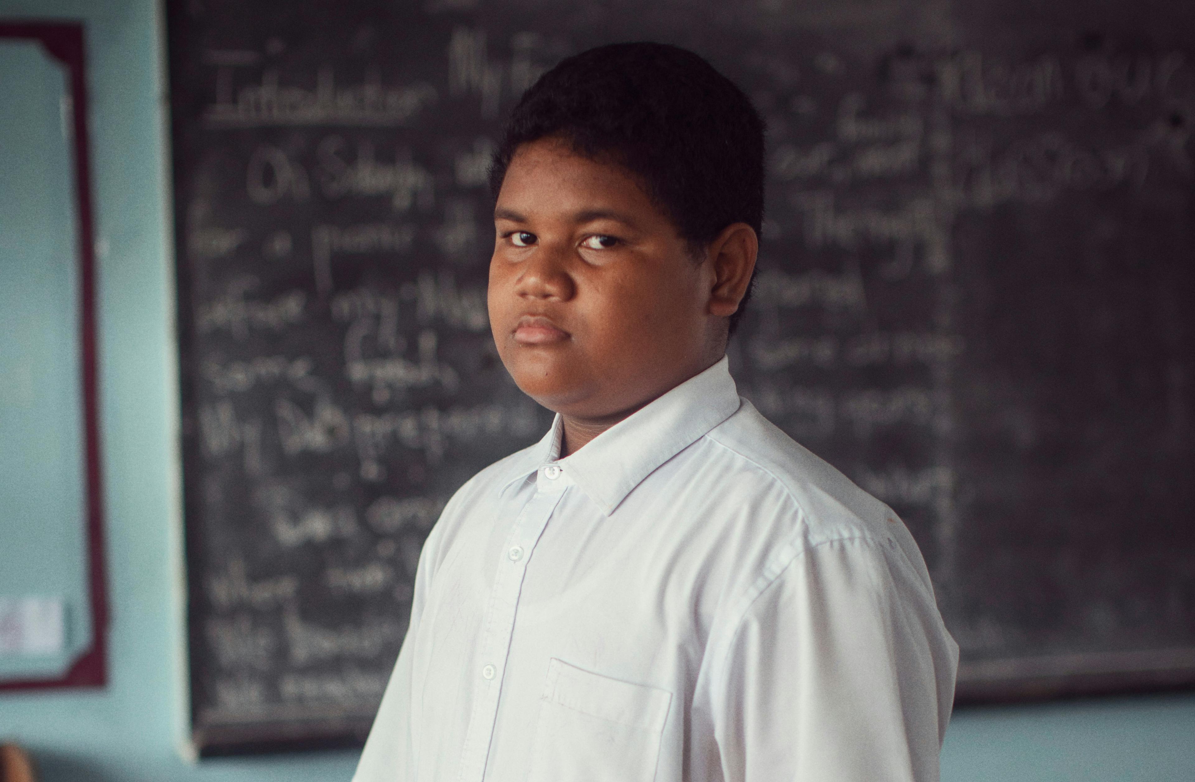 13-year-old Mono, an 8th-grade student, in his classroom at Nauti Primary School, the largest school in Tuvalu. 