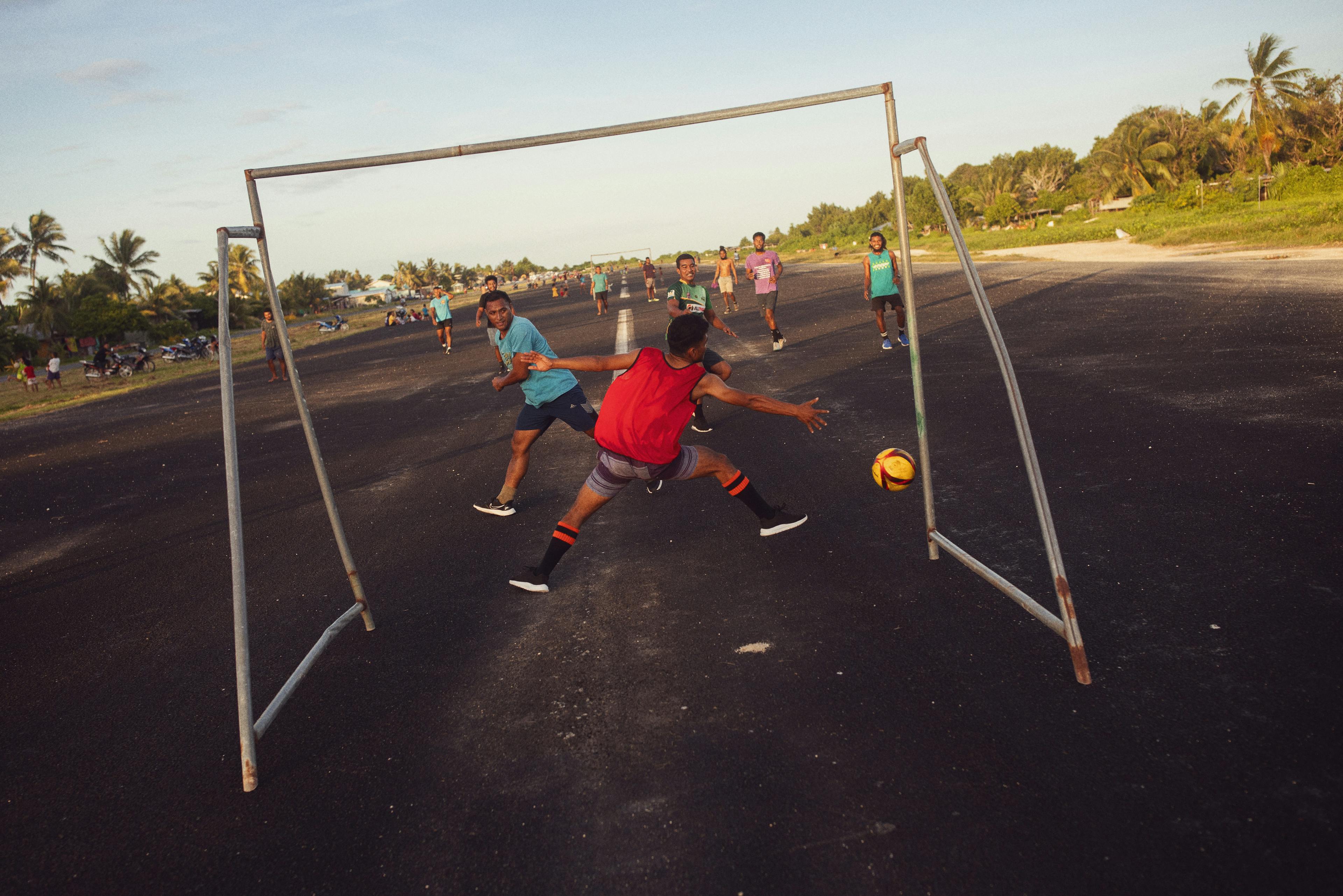 Residents play football on the runway of Tuvalu's International Airport. 