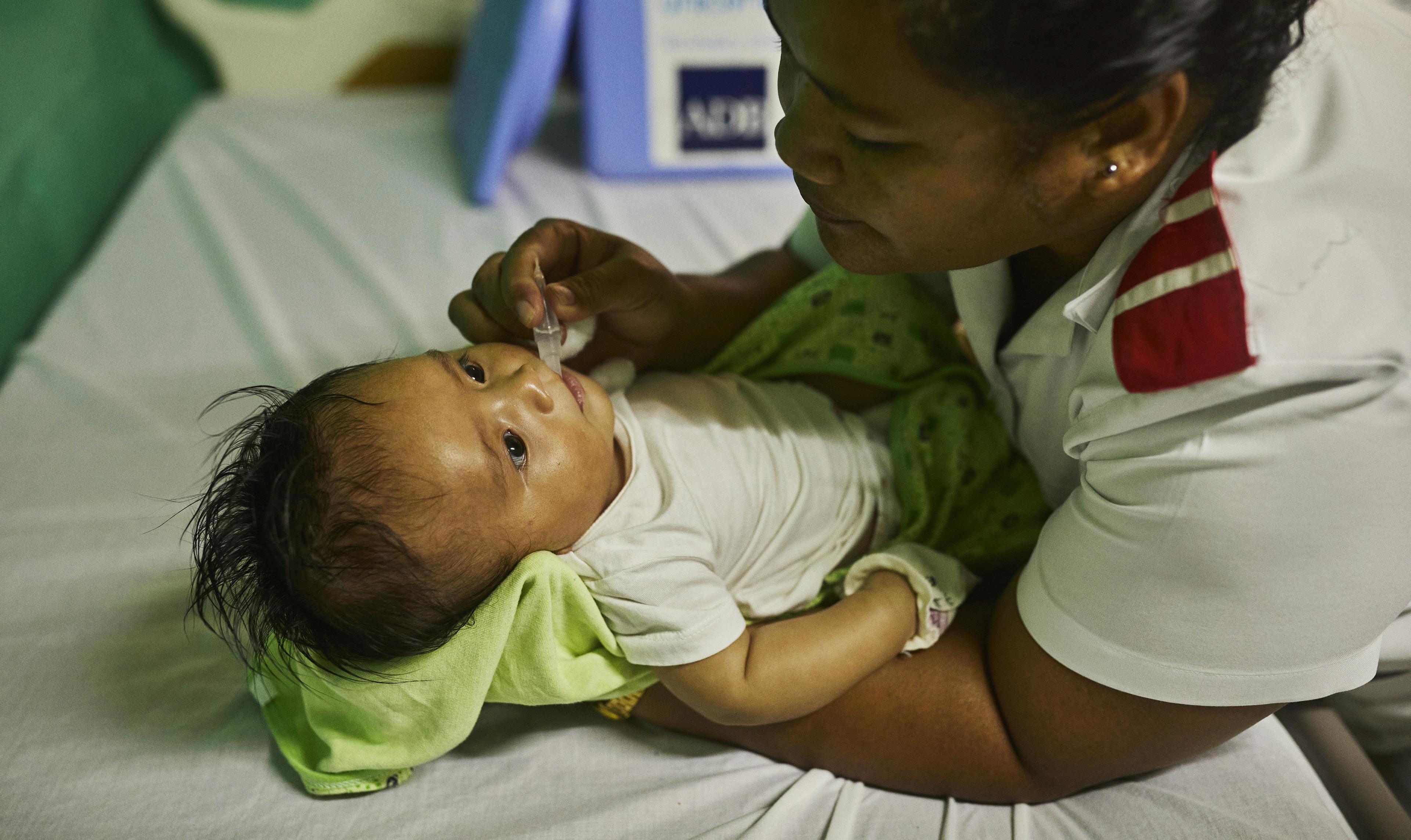 Vaccinations being administered at a clinic on the main island of Tuvalu. UNICEF ensures the safe delivery of vaccines to the isolated islands, maintaining their proper temperature throughout the journey so that they stay effective.