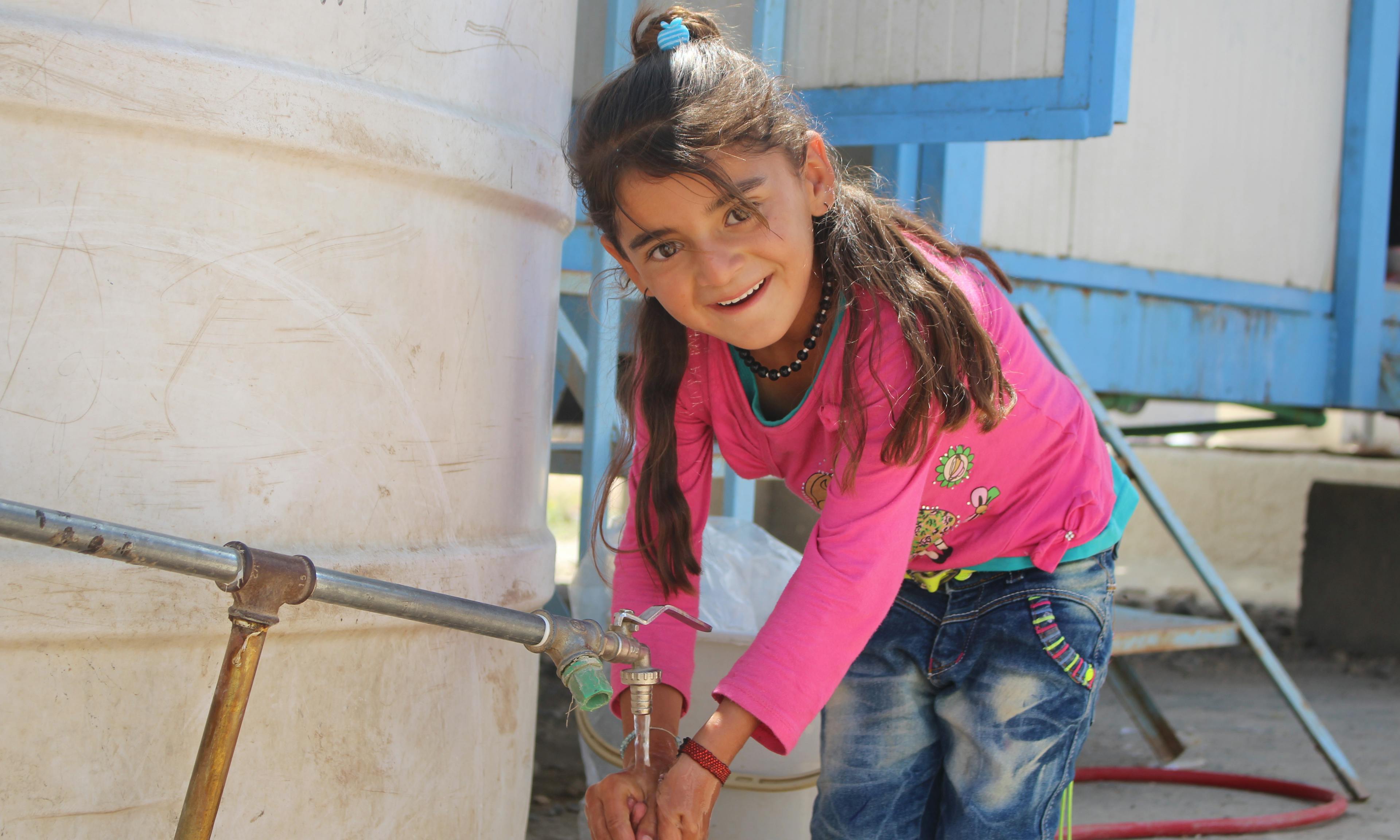 Hayman, an 8-year old, says, “Water for drinking and washing is always available in the school.” in Nowruz camp in Syria.