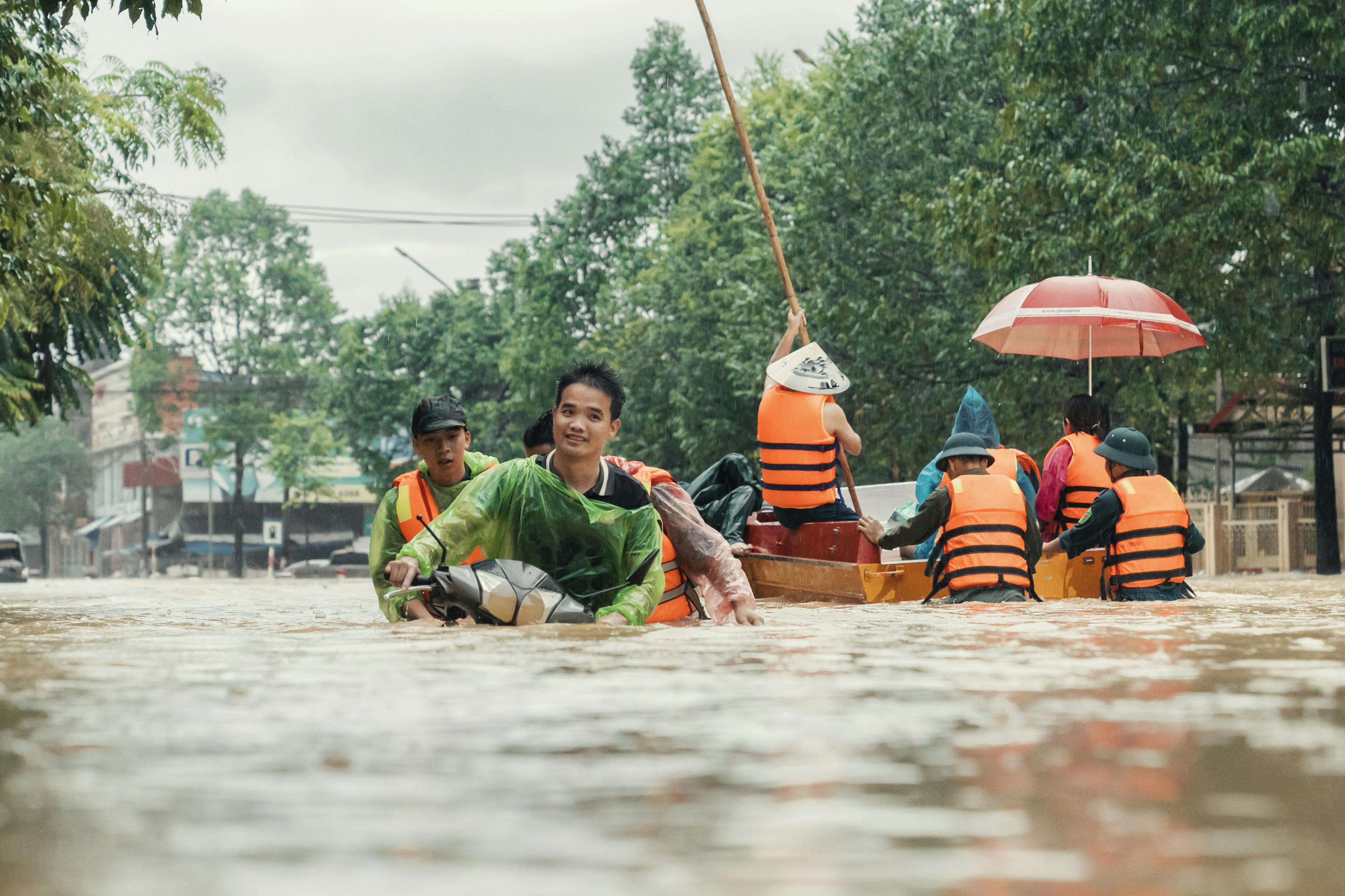 Pham Hong Viet, residing in Ba Xuyen Commune - Song Cong District - Thai Nguyen City, is leading his motorbike through the flooded area caused by super typhoon Yagi.