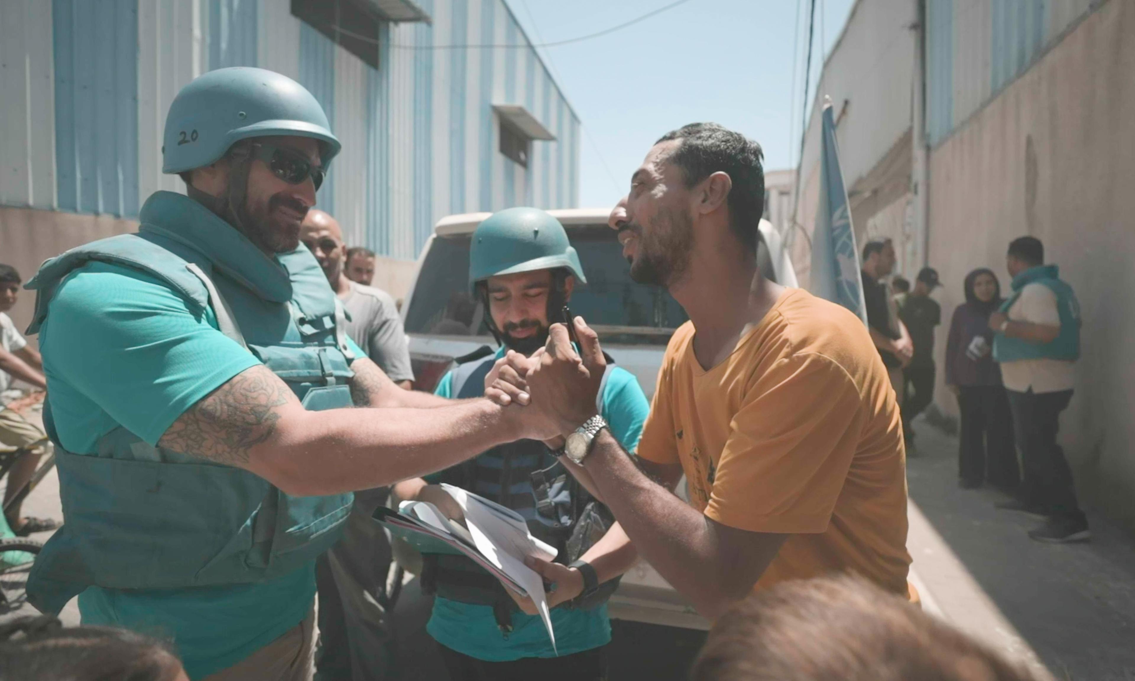 On the 6th of August, Tuesday, after being reunited with his children, Abdullah holds the hand of Matthew DeCristofano, a UNICEF staff member, Child Protection Specialist, thanking him during a mission to reunite 7 children from the south to the middle and north of Gaza with their caregivers, bringing hope to families torn apart by conflict.