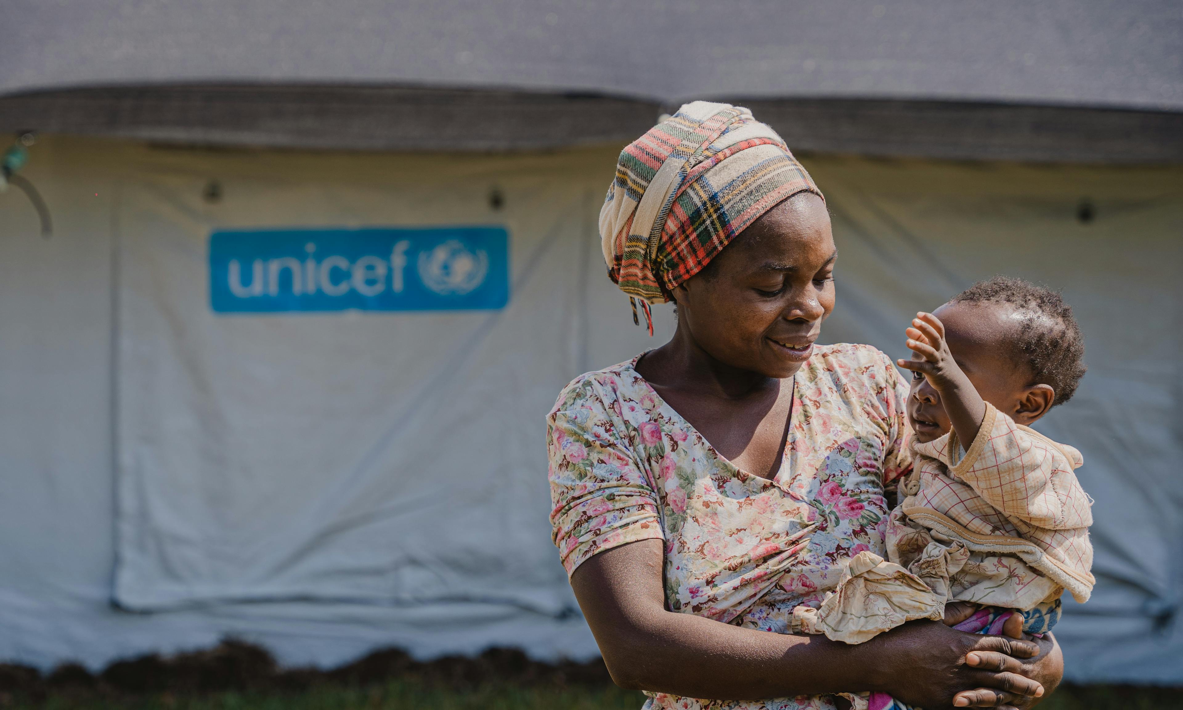 Neema holds her 1-year-old daughter Joseline outside the UNICEF-supported mpox isolation and treatment unit at Lwiro Hospital in South Kivu province, DR Congo