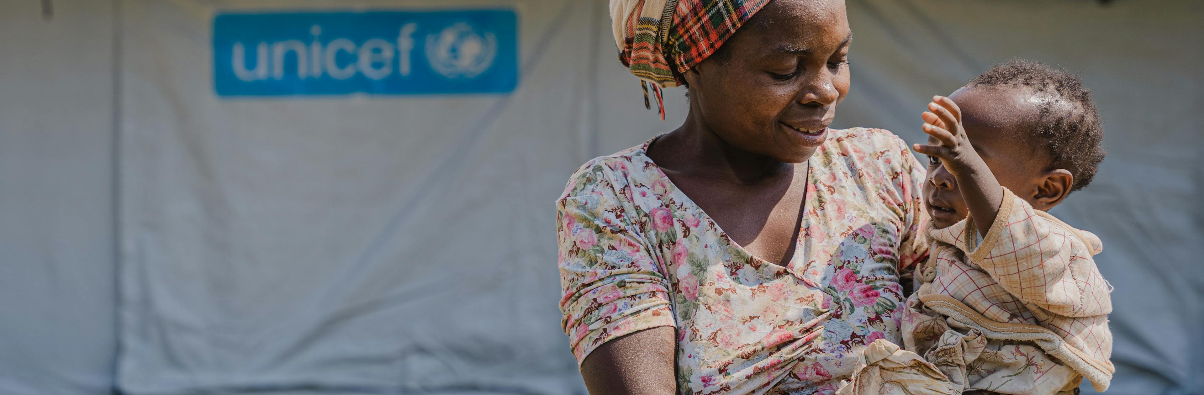 Neema holds her 1-year-old daughter Joseline outside the UNICEF-supported mpox isolation and treatment unit at Lwiro Hospital in South Kivu province, DR Congo