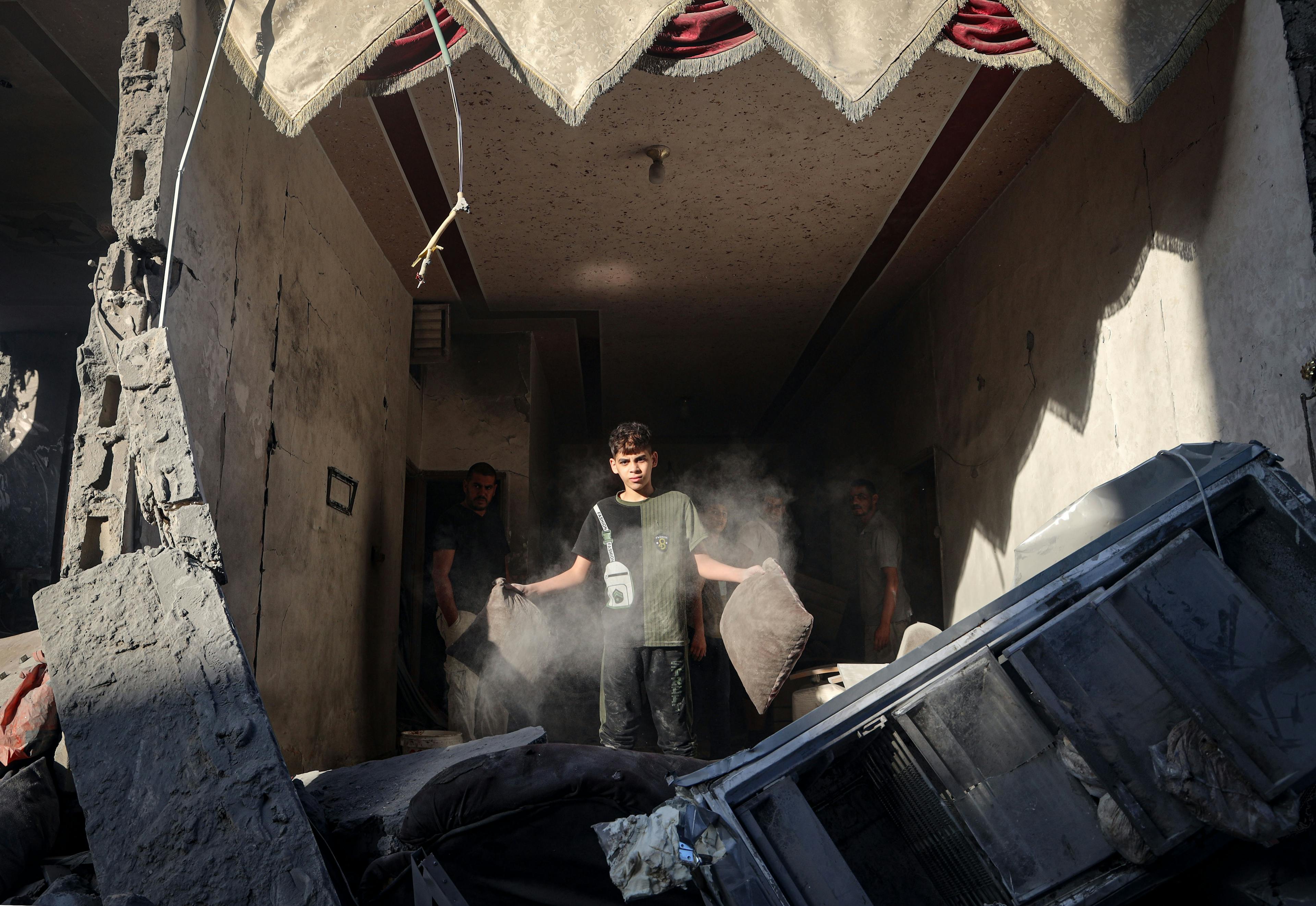 October 2023: 9 -year-old Ahmad, standing inside the rubble of his house destroyed by an aerial bombardment in Rafah city, due to the continues hostilities in the Gaza Strip.