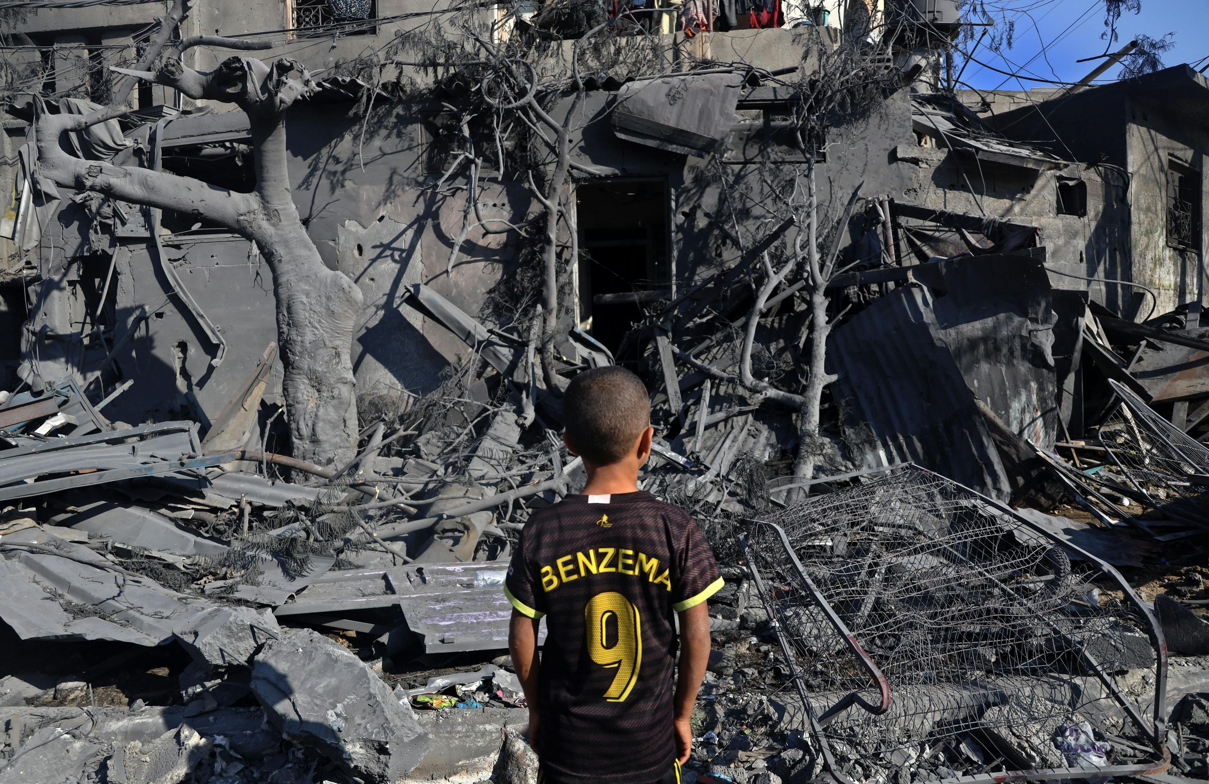 November 2023: A child from the city of Rafah stands in front of his family house, which was targeted by an airstrike, during the ongoing hostilities in the Gaza Strip.