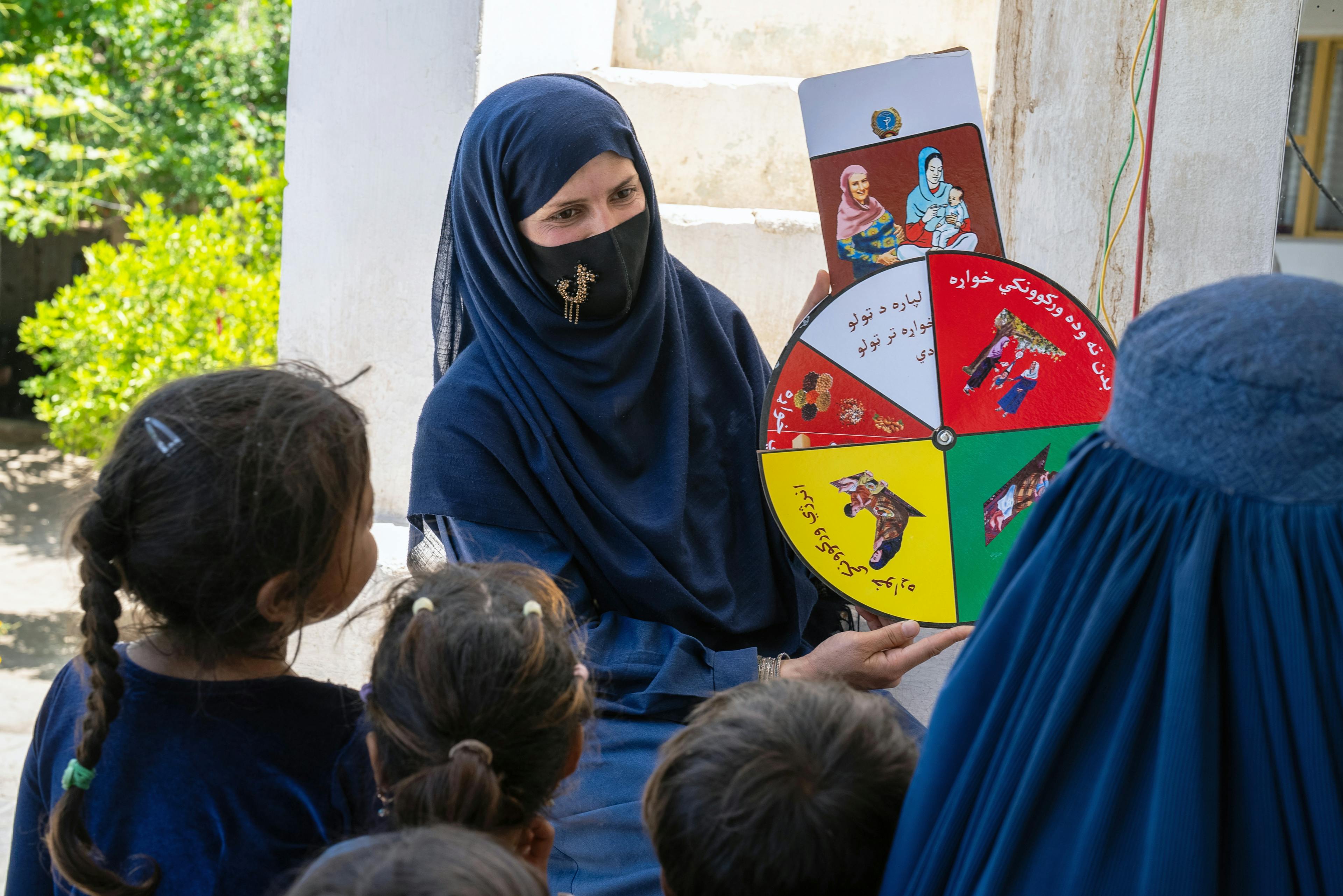 Madina, a community health worker, educates mothers about good nutrition at the UNICEF-supported Qalai Ishaq health post in Nangarhar province, eastern Afghanistan. 