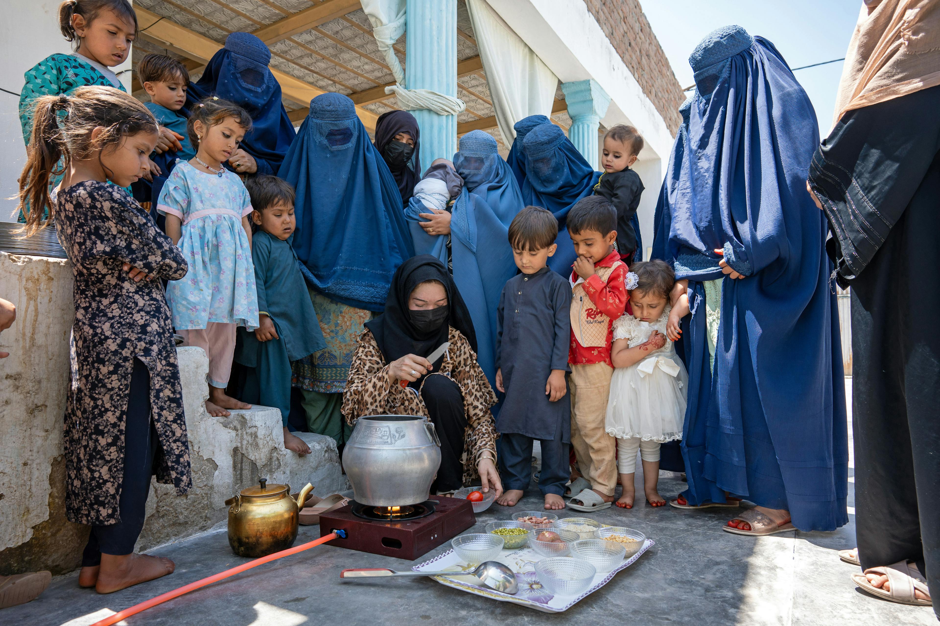 A volunteer, shows mothers how to cook a nutritious meal at the UNICEF-supported Qalai Ishaq health post in Nangarhar province, eastern Afghanistan.