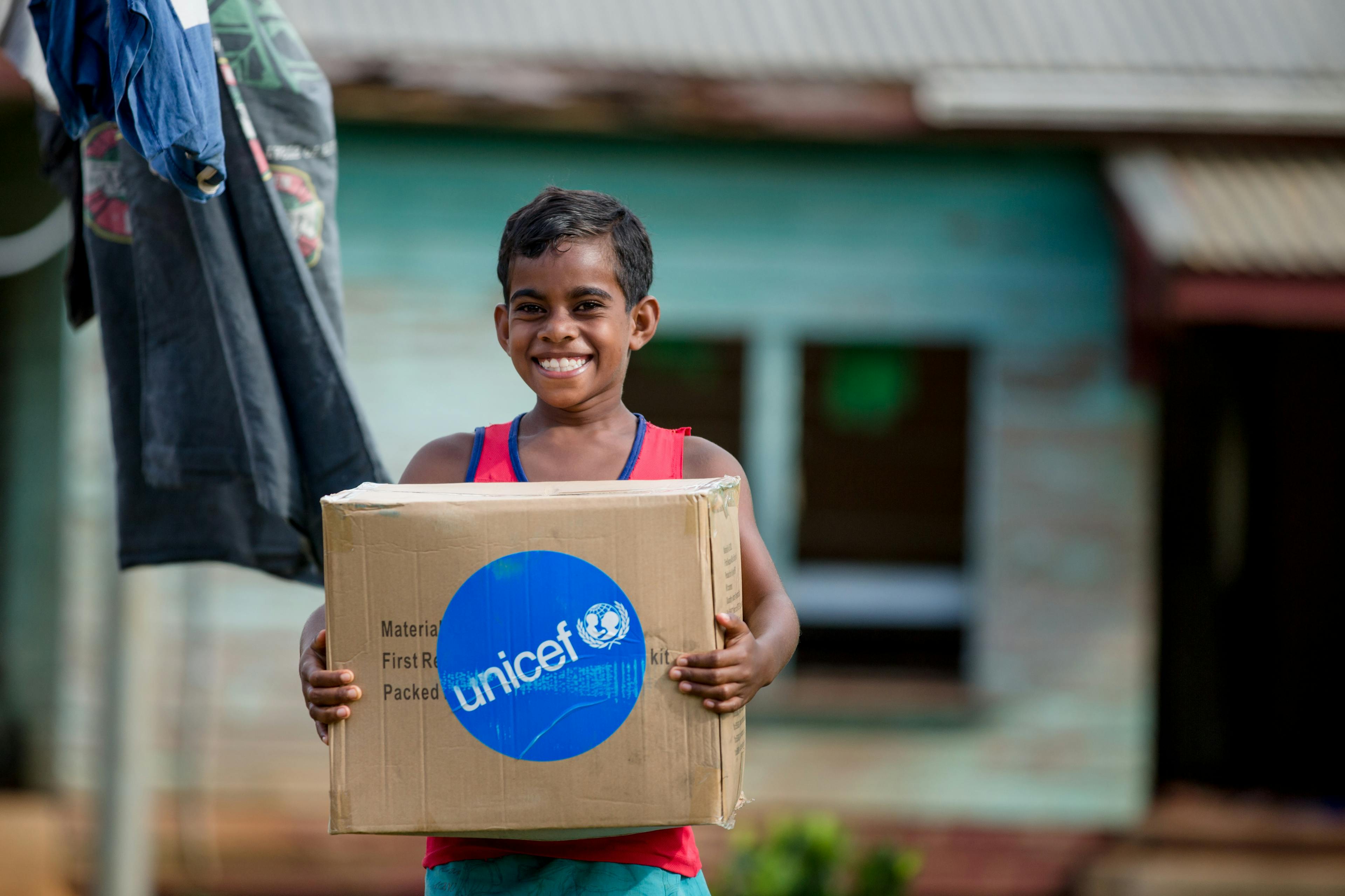 8-year-old Asinate Catanavula receives a Water & hygiene kit at Tavea Village,Bua - Fiji.