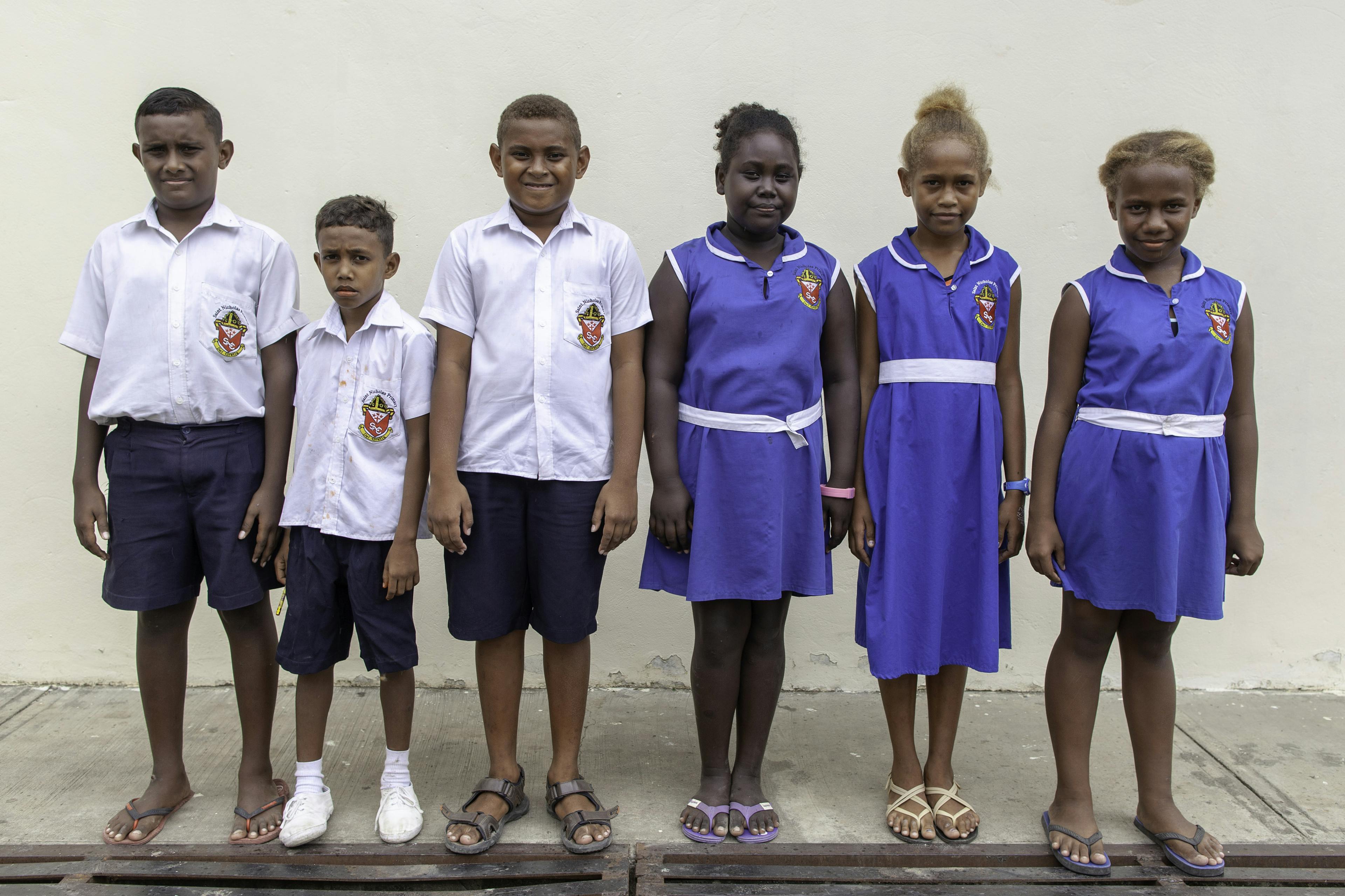 On 26 August, 2019, (second from left) 9 Nino Devesi (9) stands with classmates of the same age in Guadalcanal, Solomon Islands.