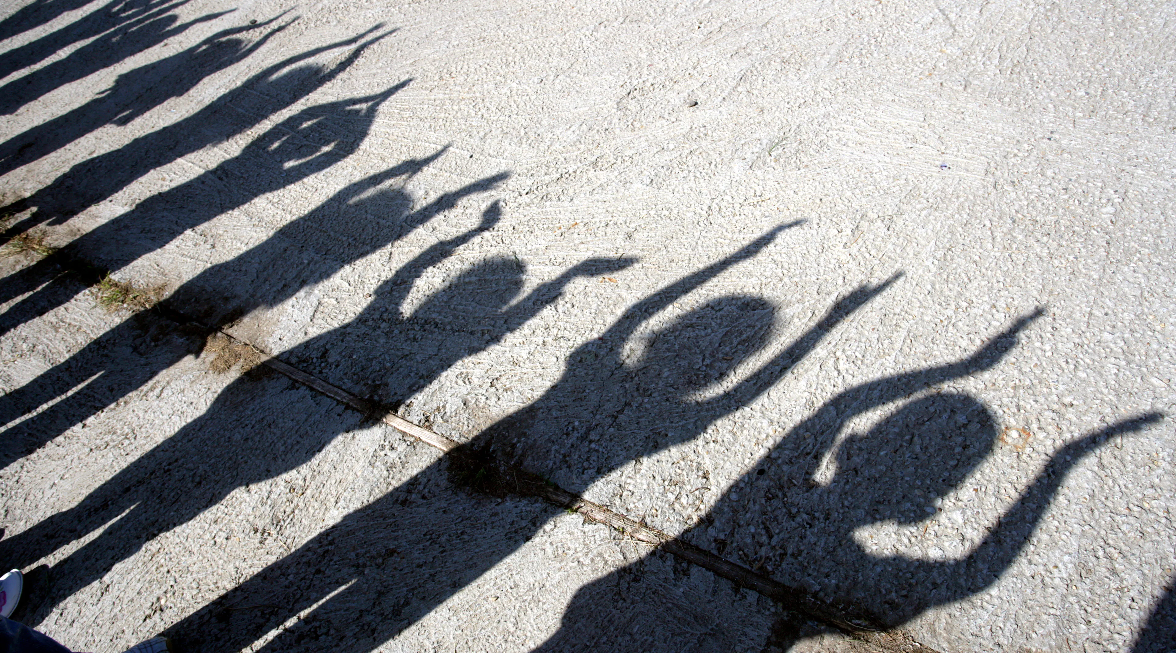 shadow of children with hands up