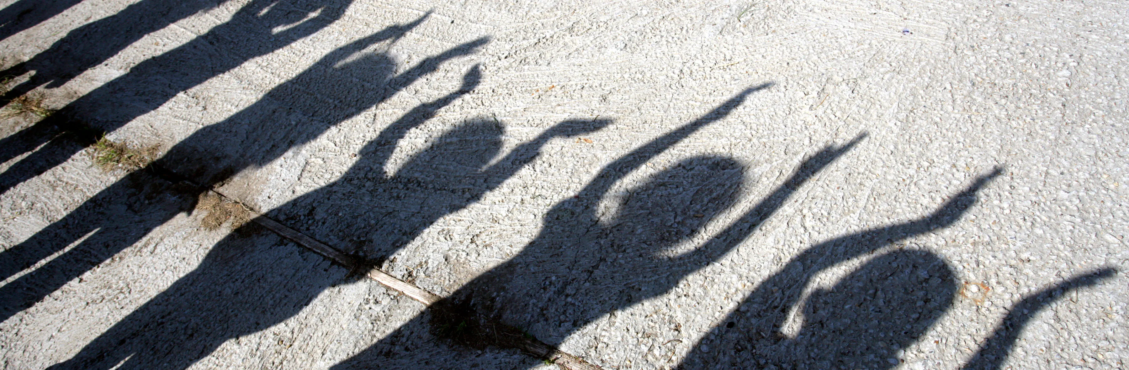 shadow of children with hands up