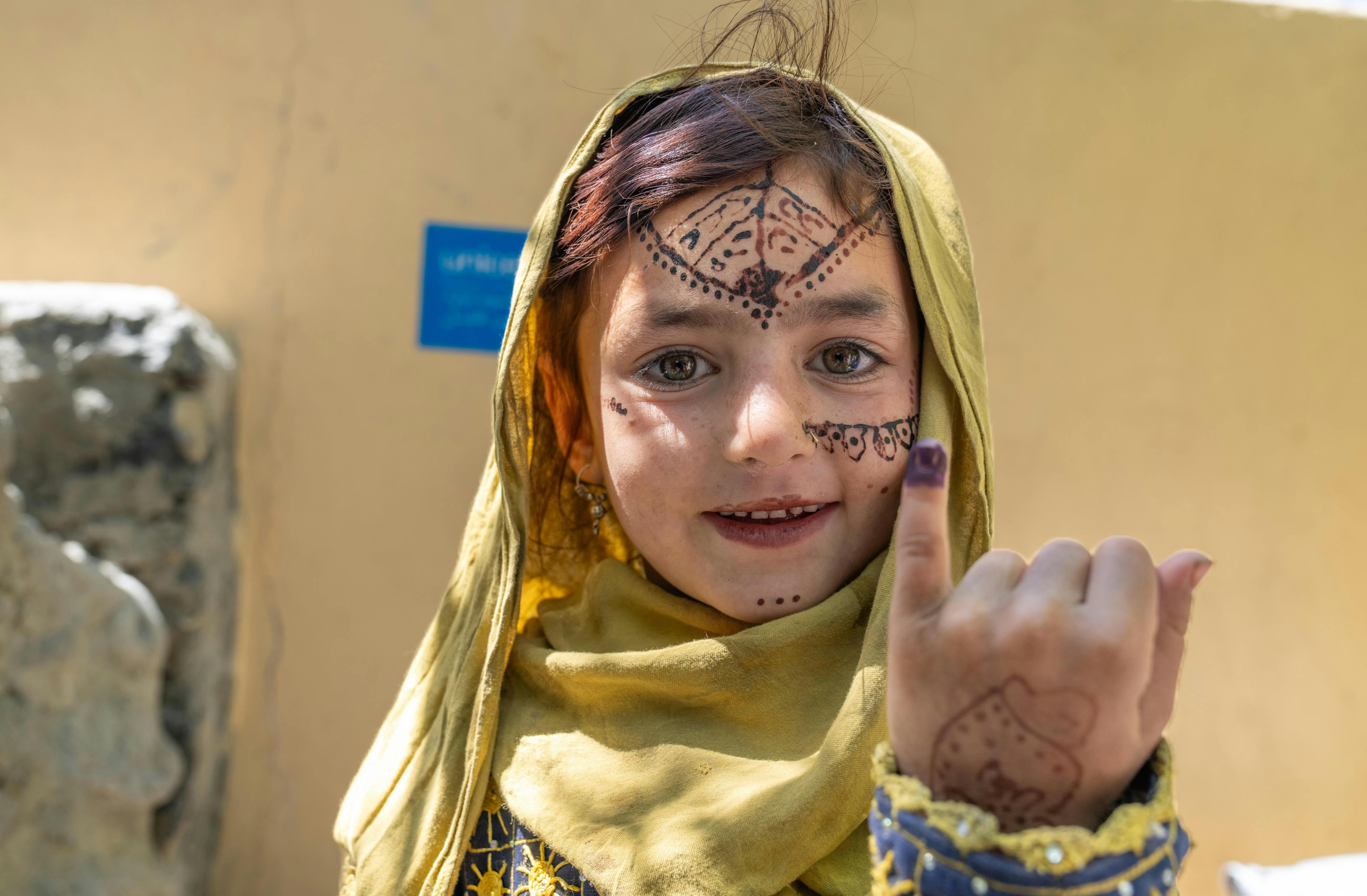 A girl in Khost Province, Southeastern Afghanistan, shows her marked finger after receiving the polio vaccination. The work of Female Mobiliser Vaccinators has bene crucial in reducing the number of children missing vaccination in the province.