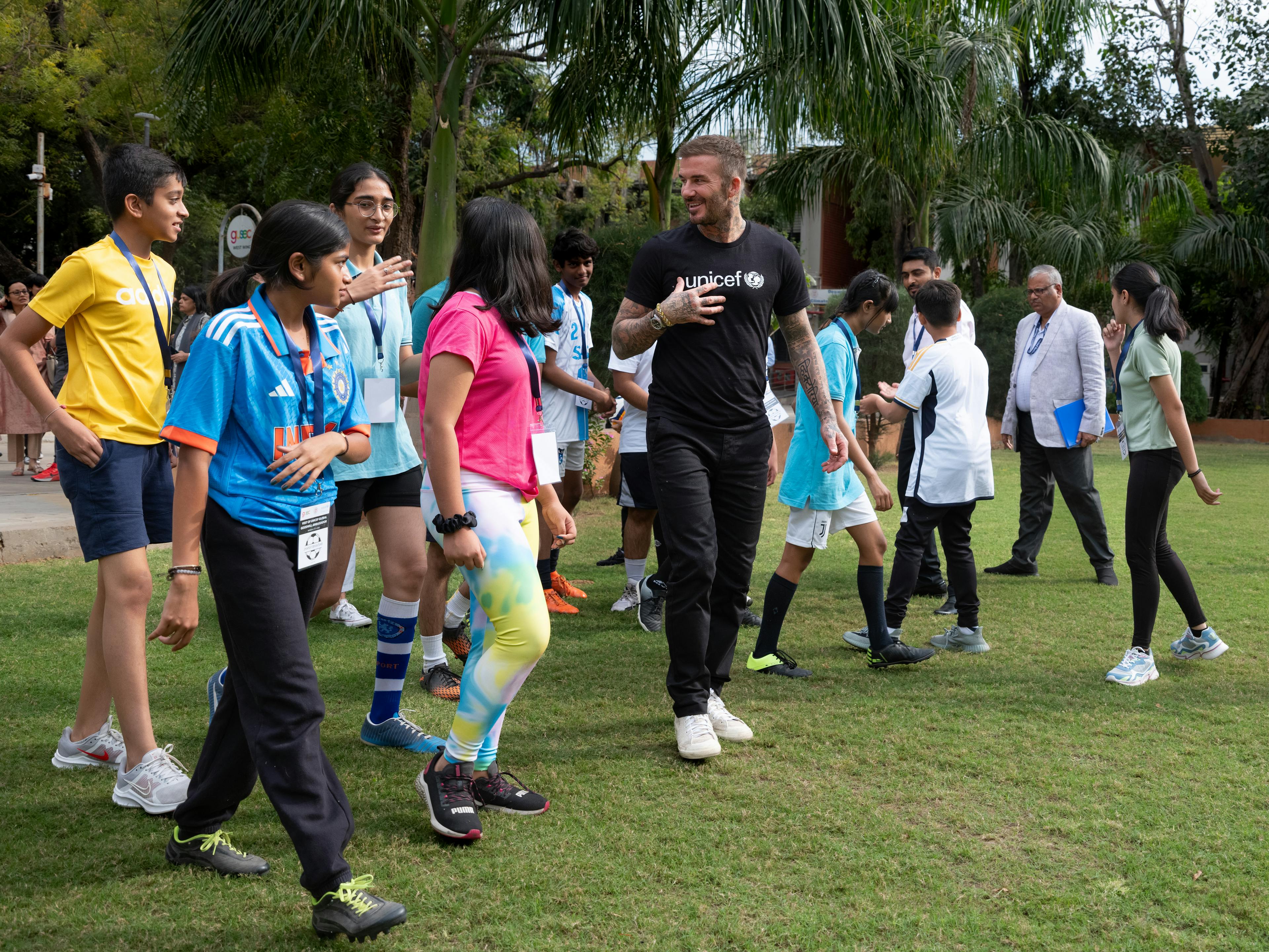 On 13 November 2023 in India, UNICEF Goodwill Ambassador David Beckham (centre) gets ready to play a friendly game of football with children at Gujarat University in Ahmedabad. 