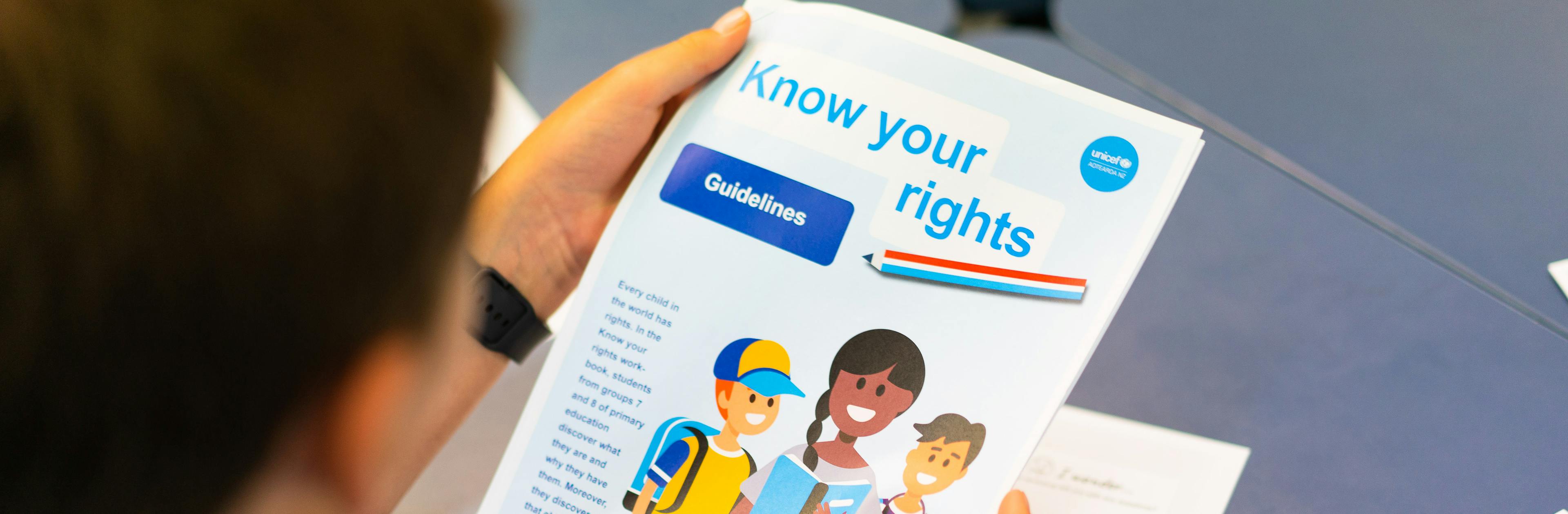 A student in New Zealand reading a document about the UN Charter on the Rights of the Child