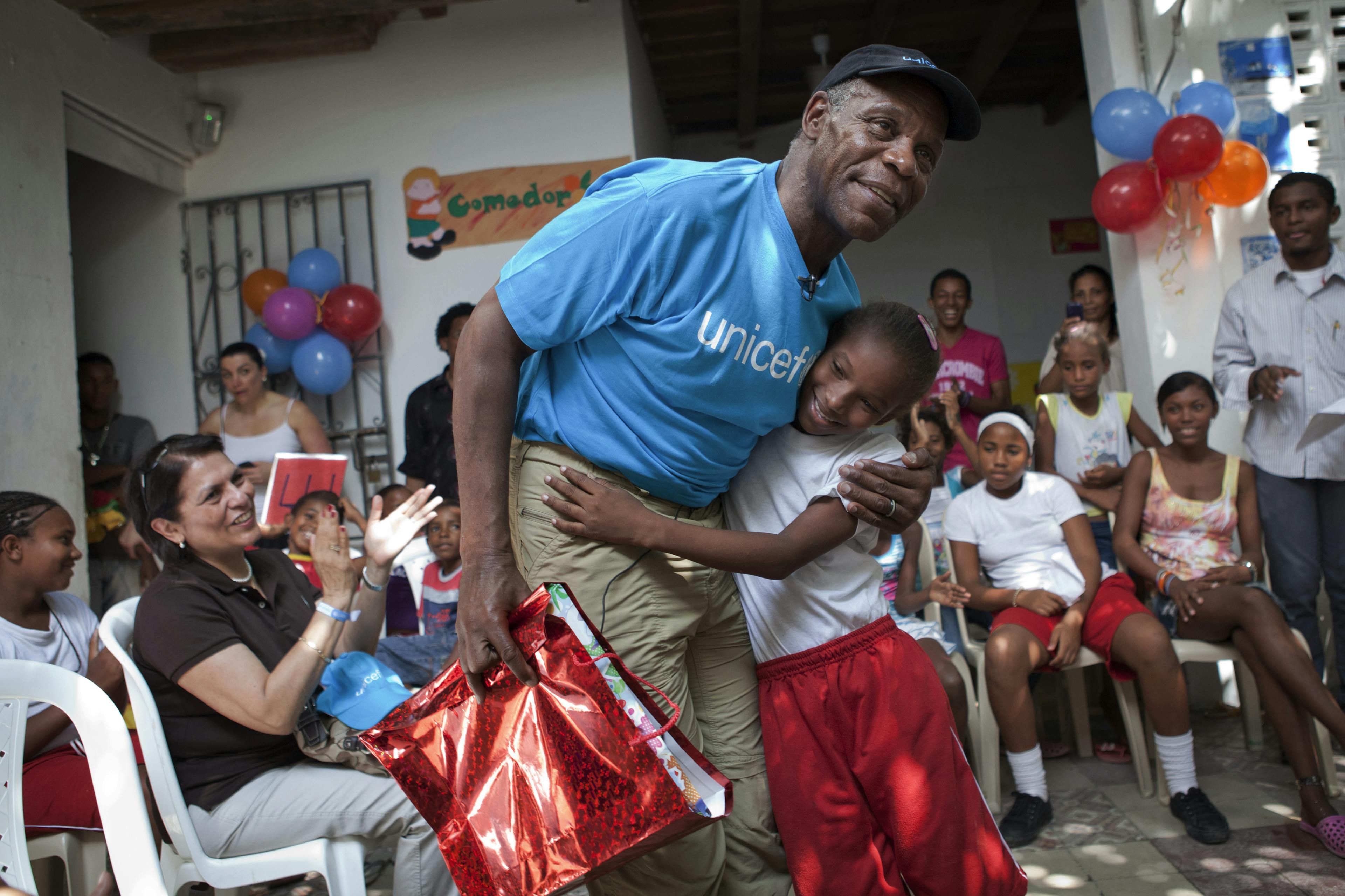 UNICEF Goodwill Ambassador and Hollywood star, Danny Glover embraces a girl who has presented him with a gift, at the La Boquilla centre in Cartagena, capital of Bolivar Department, 2011.