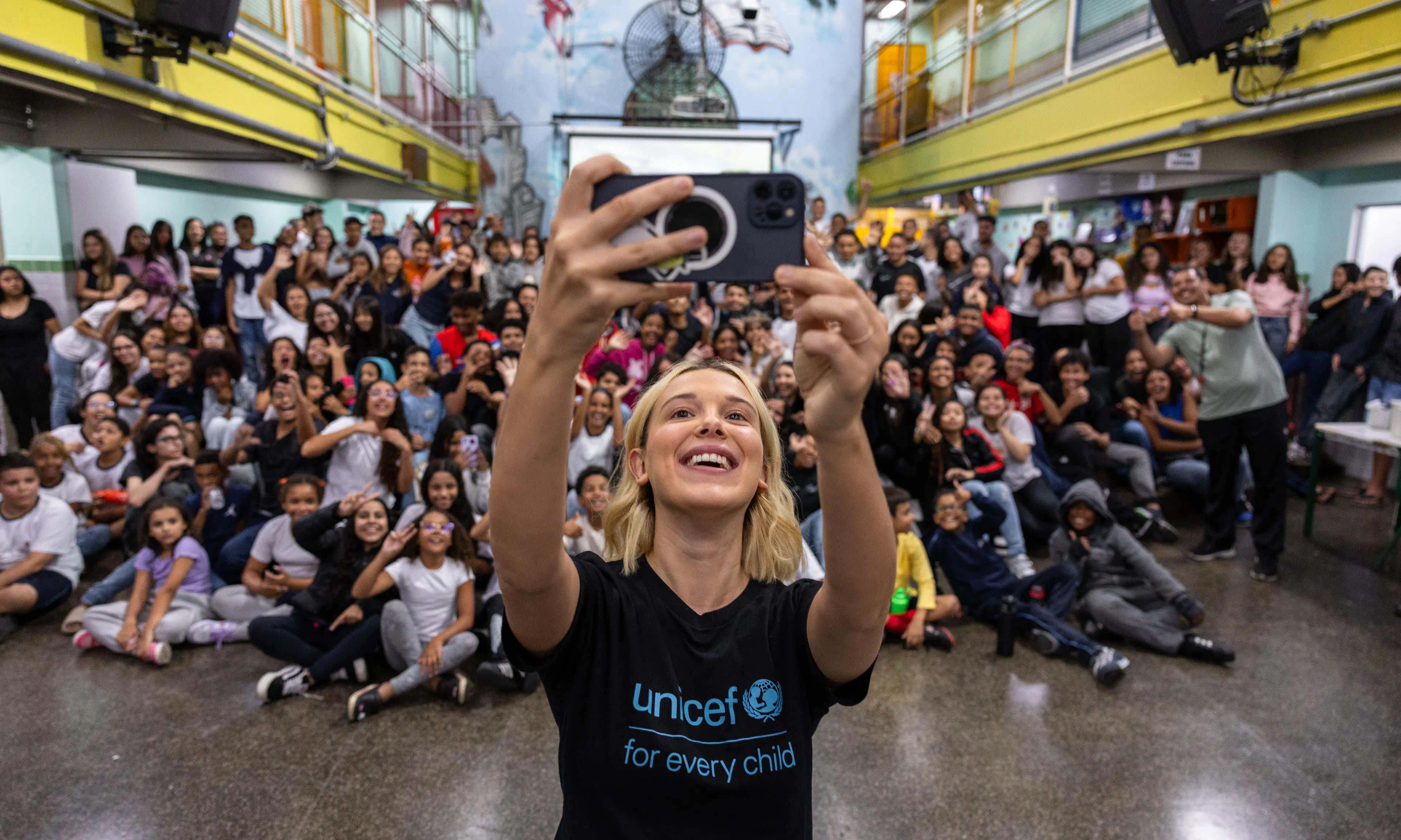 On 17 March 2025 in São Paulo, Brazil, UNICEF Goodwill Ambassador Millie Bobby Brown takes a selfie with the students at Olinda Menezes Serra Vidal Elementary School, which is located in a vulnerable neighbourhood where UNICEF operates.