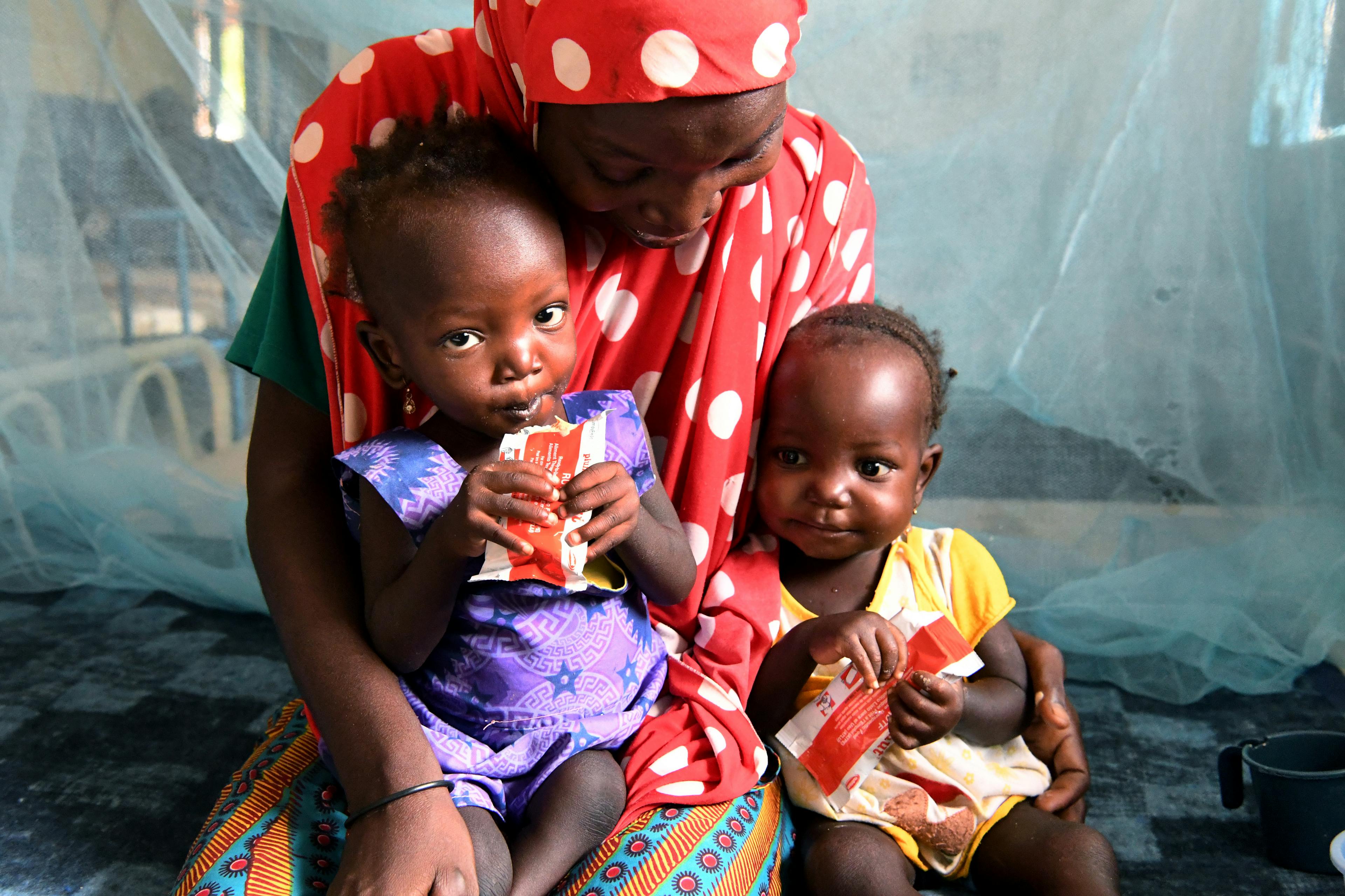 Nana Hadiza, a 28 years old woman with her 20 months old twins Housseina and Hassana, at the CHU Hospital of Maradi, in the South of Niger.