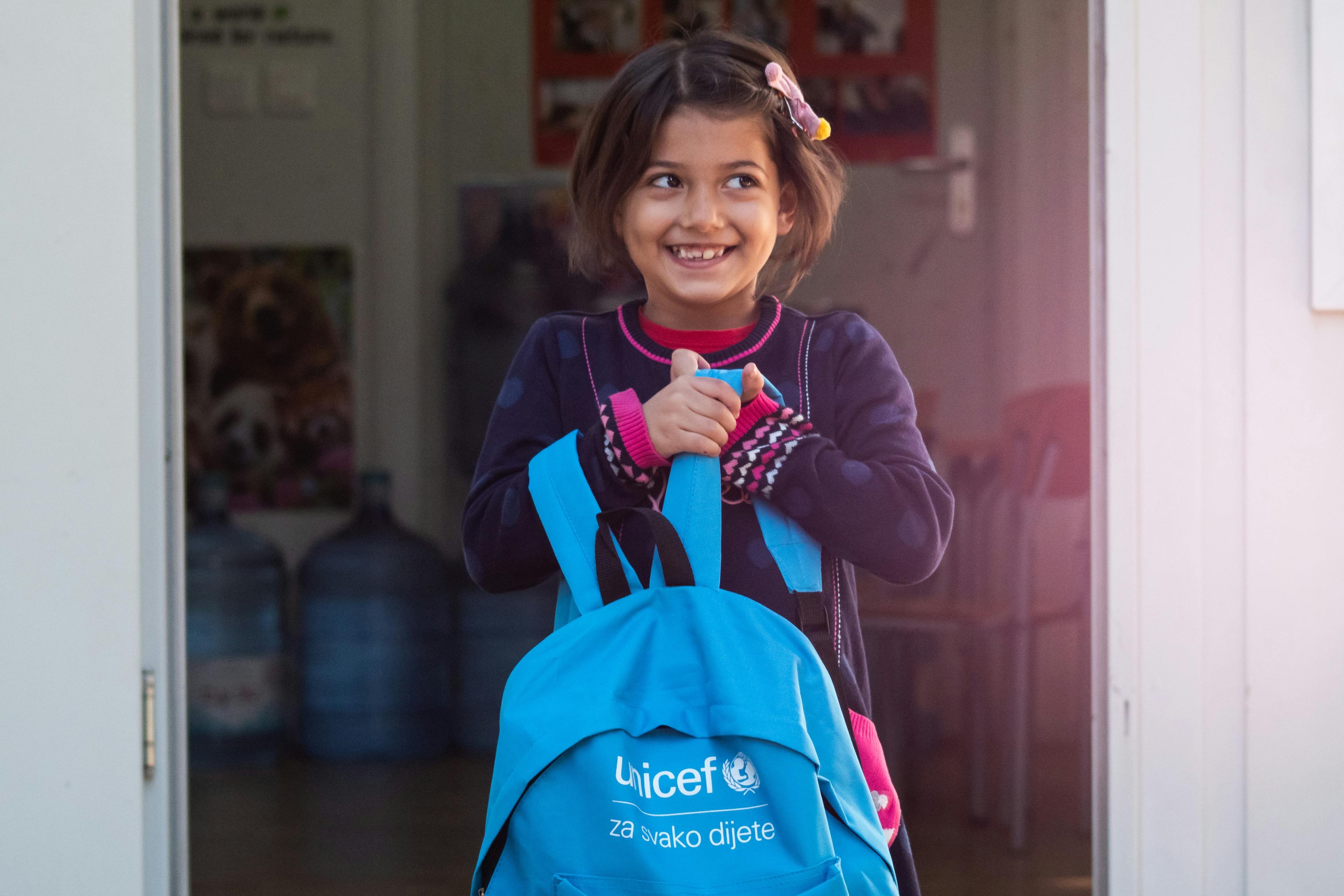 "I am happy to go to school today. I like drawing the most. My mother taught me English, and now I will learn Bosnian. When I grow up, I want to be a doctor and a model,”says Asal, whose entire attention is now focused on the contents of her new school bag.