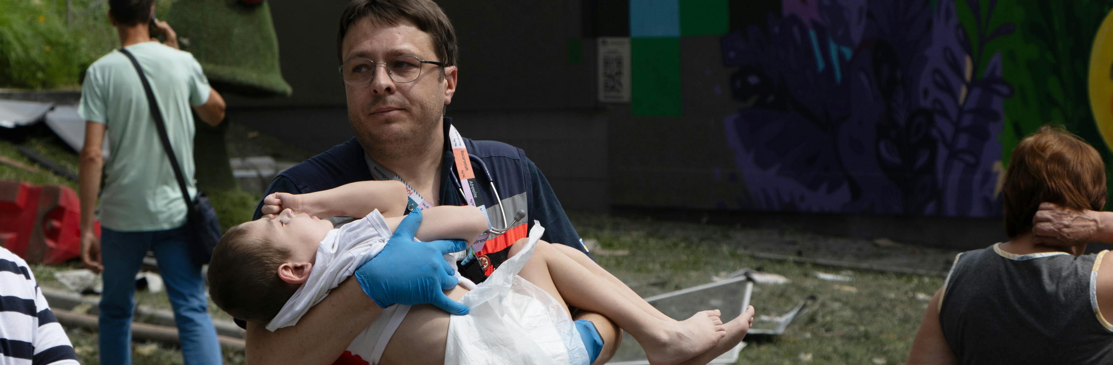 On 8 July 2024 in Kyiv, a resource worker carried a child as first responders, hospital staff and volunteers clear the rubble and search for people trapped under debris after an attack that hit Okhmatdyt hospital, Ukraine's largest children's medical centre.