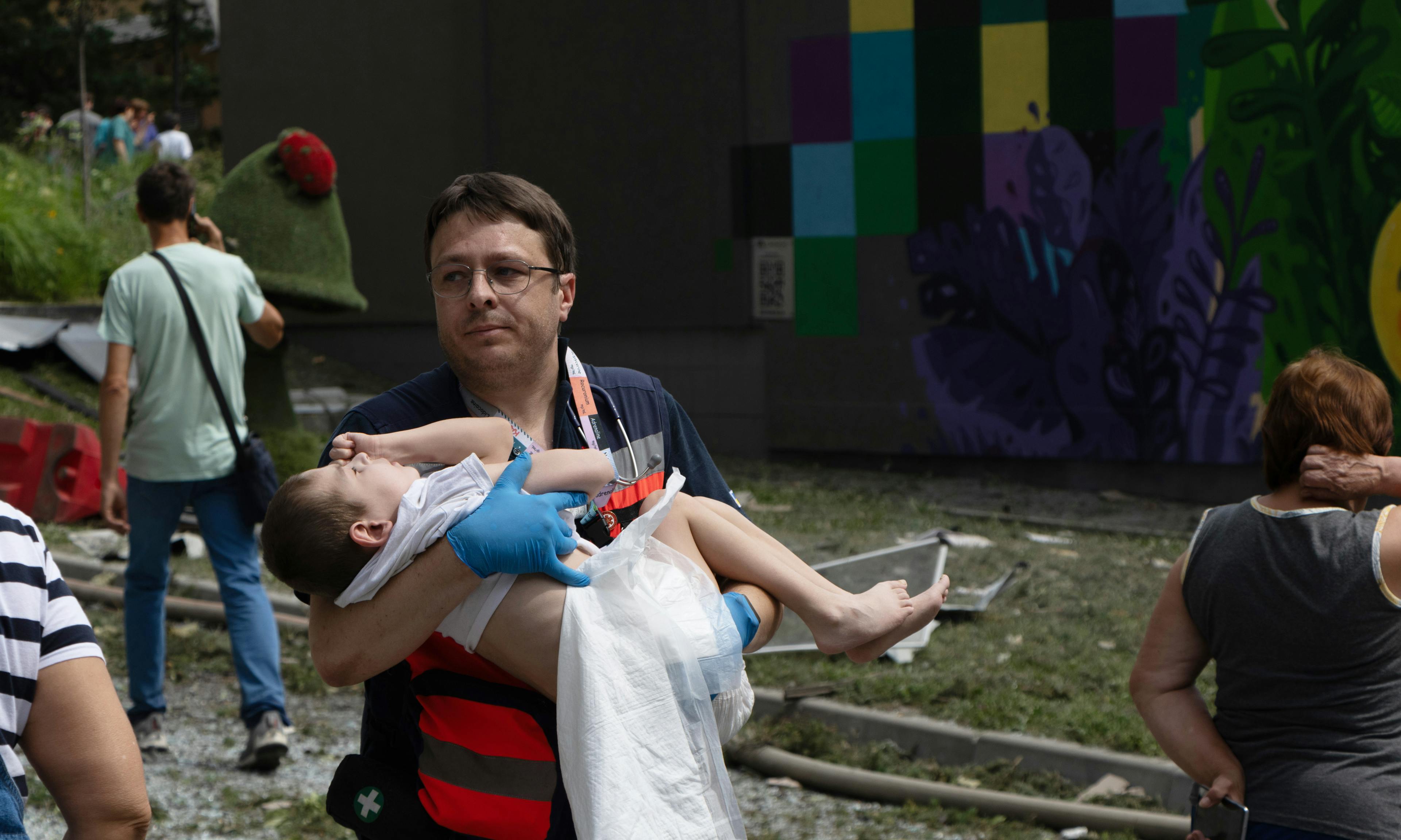 On 8 July 2024 in Kyiv, a resource worker carried a child as first responders, hospital staff and volunteers clear the rubble and search for people trapped under debris after an attack that hit Okhmatdyt hospital, Ukraine's largest children's medical centre.