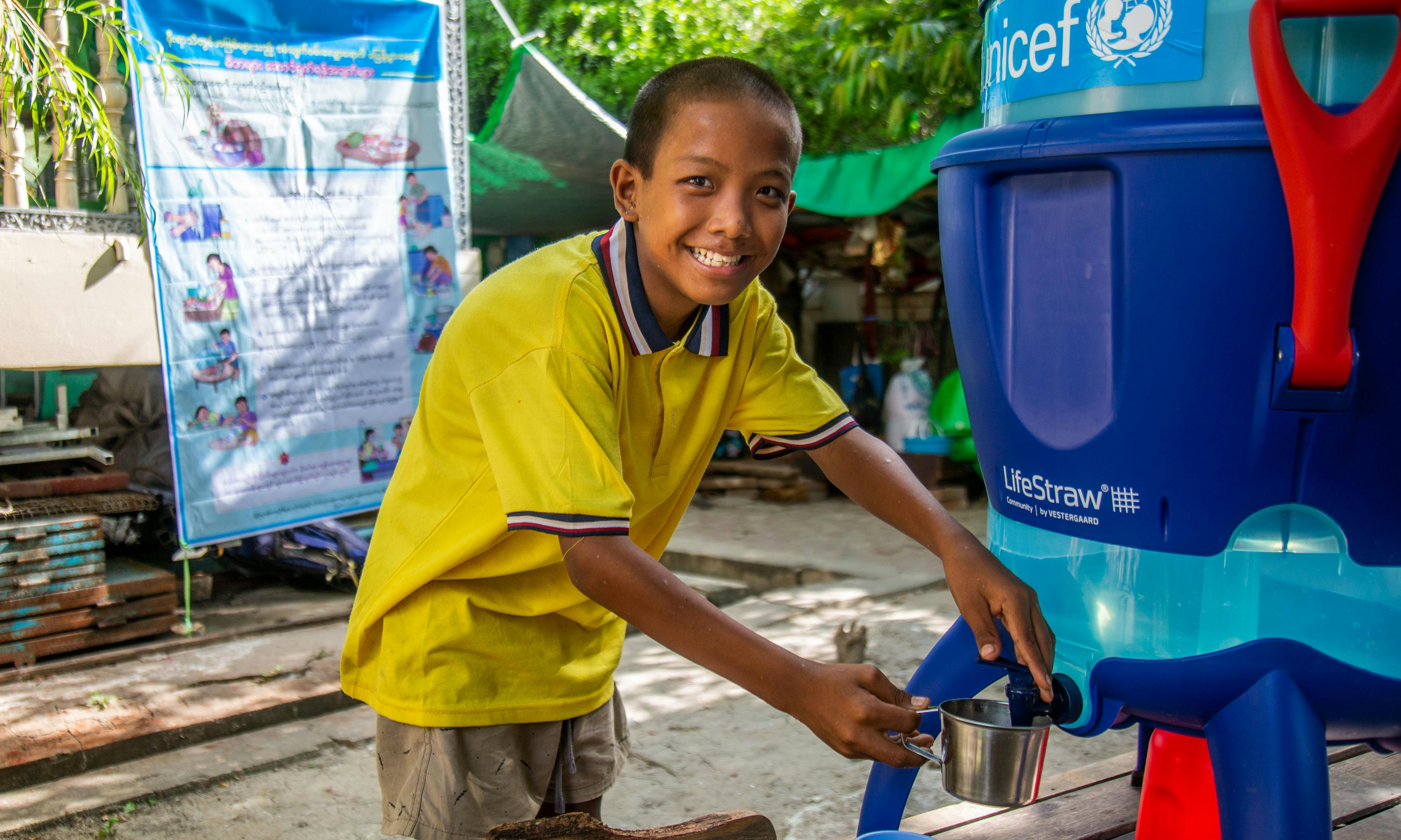 Child with UNICEF water fountain