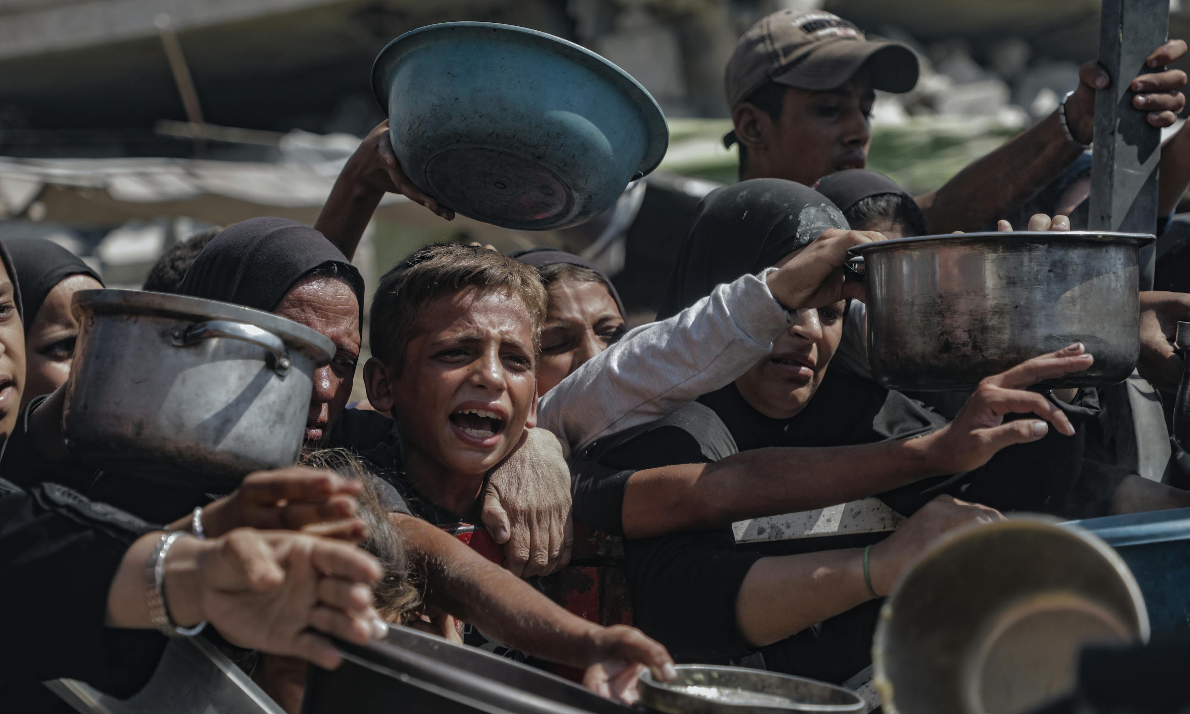 Children in Gaza, July 2025, trying to get food from aid distribution centers.