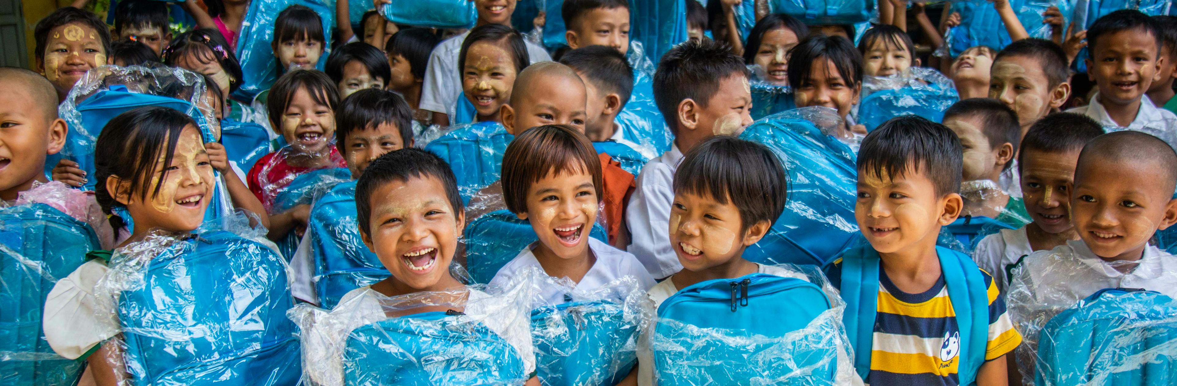 Children with cyan blue UNICEF school bags