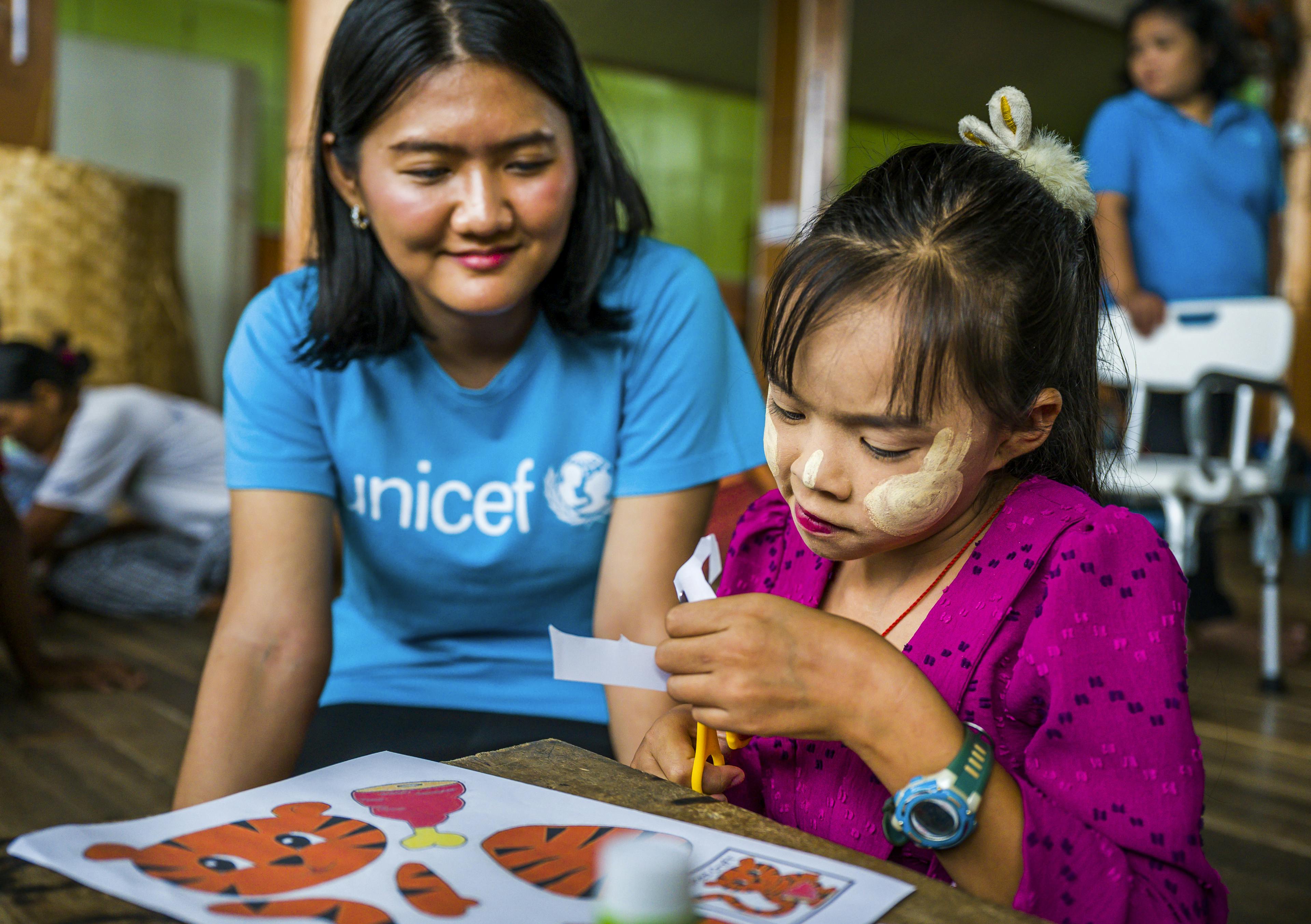 UNICEF aid worker in child in Myanmar